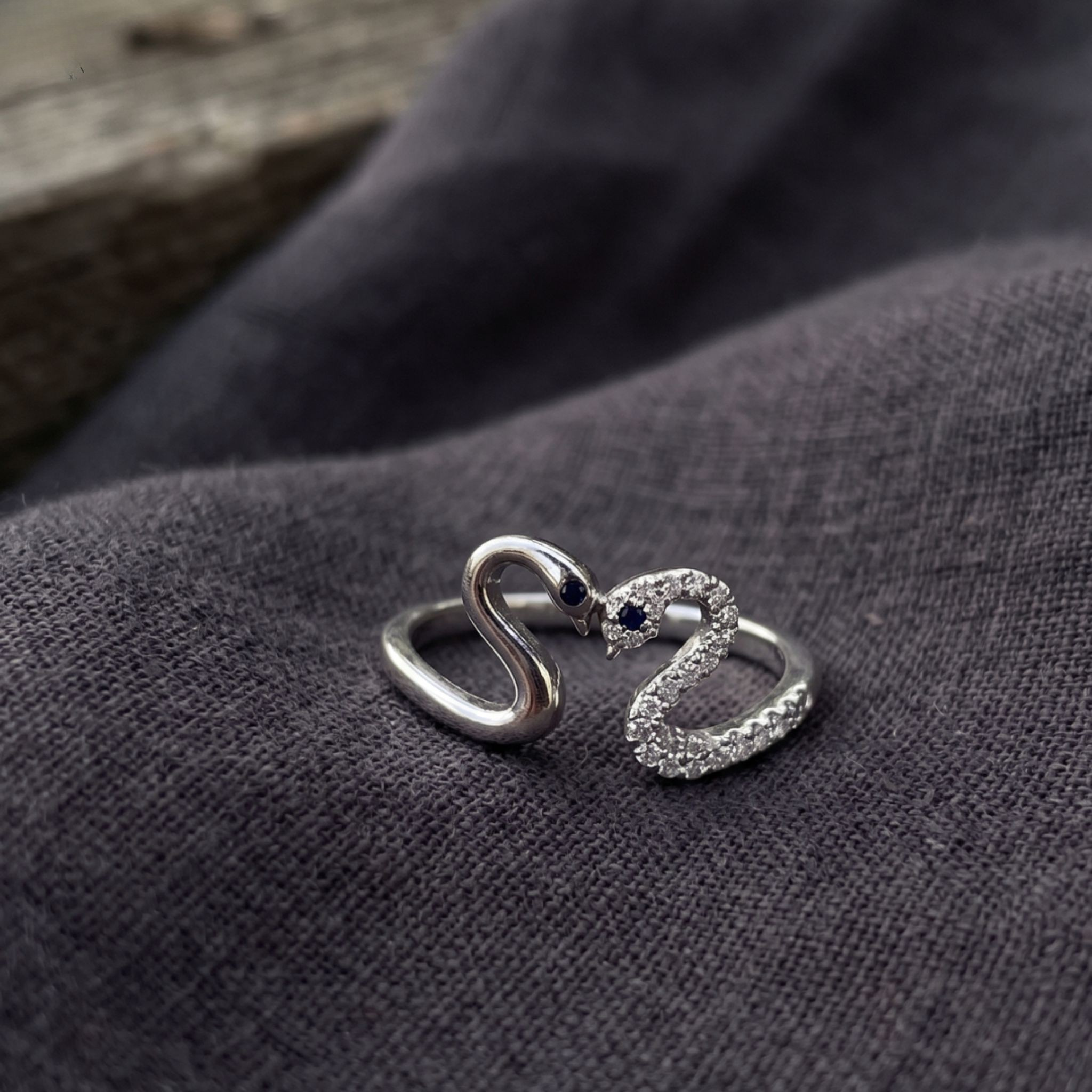 Romantic open ring featuring two swans forming a heart-shaped design.