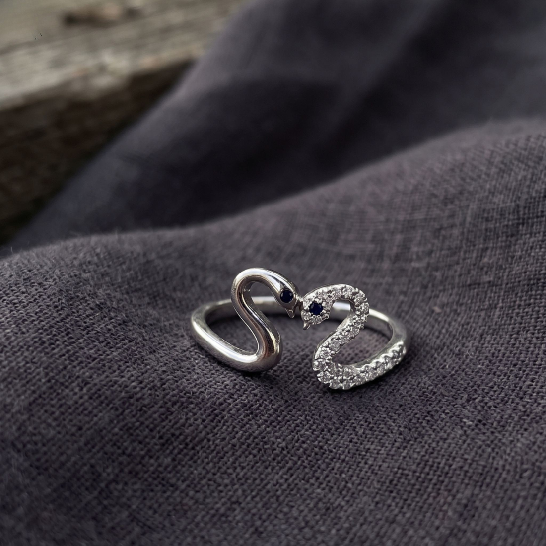 Romantic open ring featuring two swans forming a heart-shaped design.