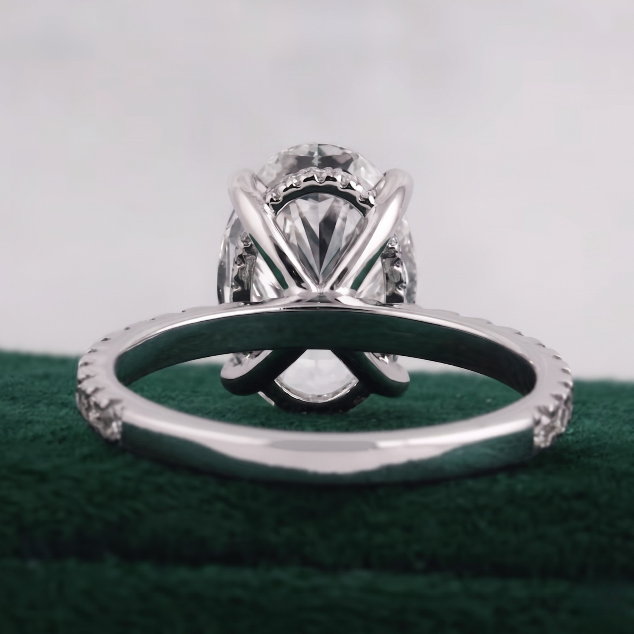 Oval solitaire engagement ring with twelve round diamond accents