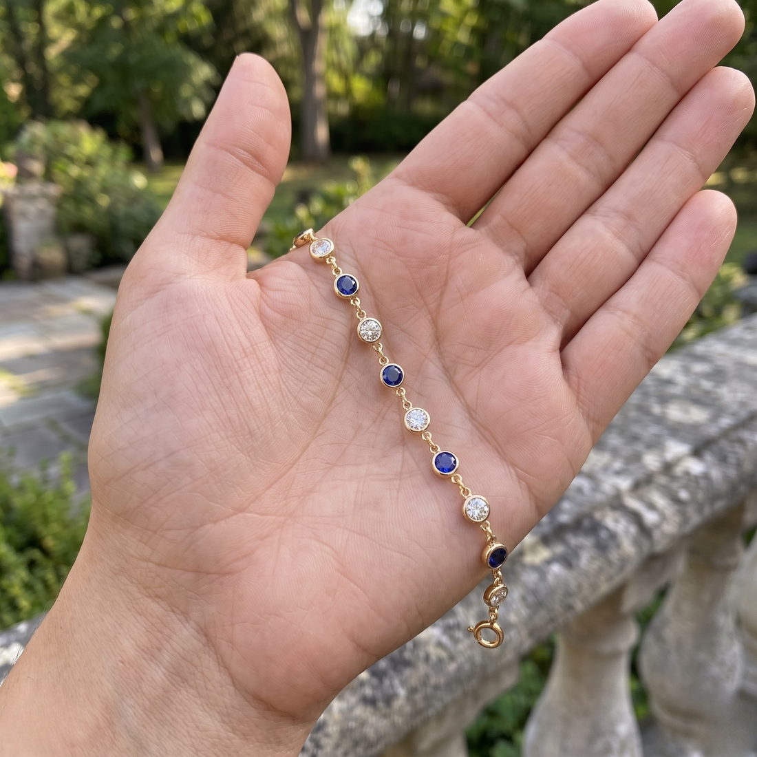 Luxury tennis bracelet with round blue gemstones and brilliant white diamonds.