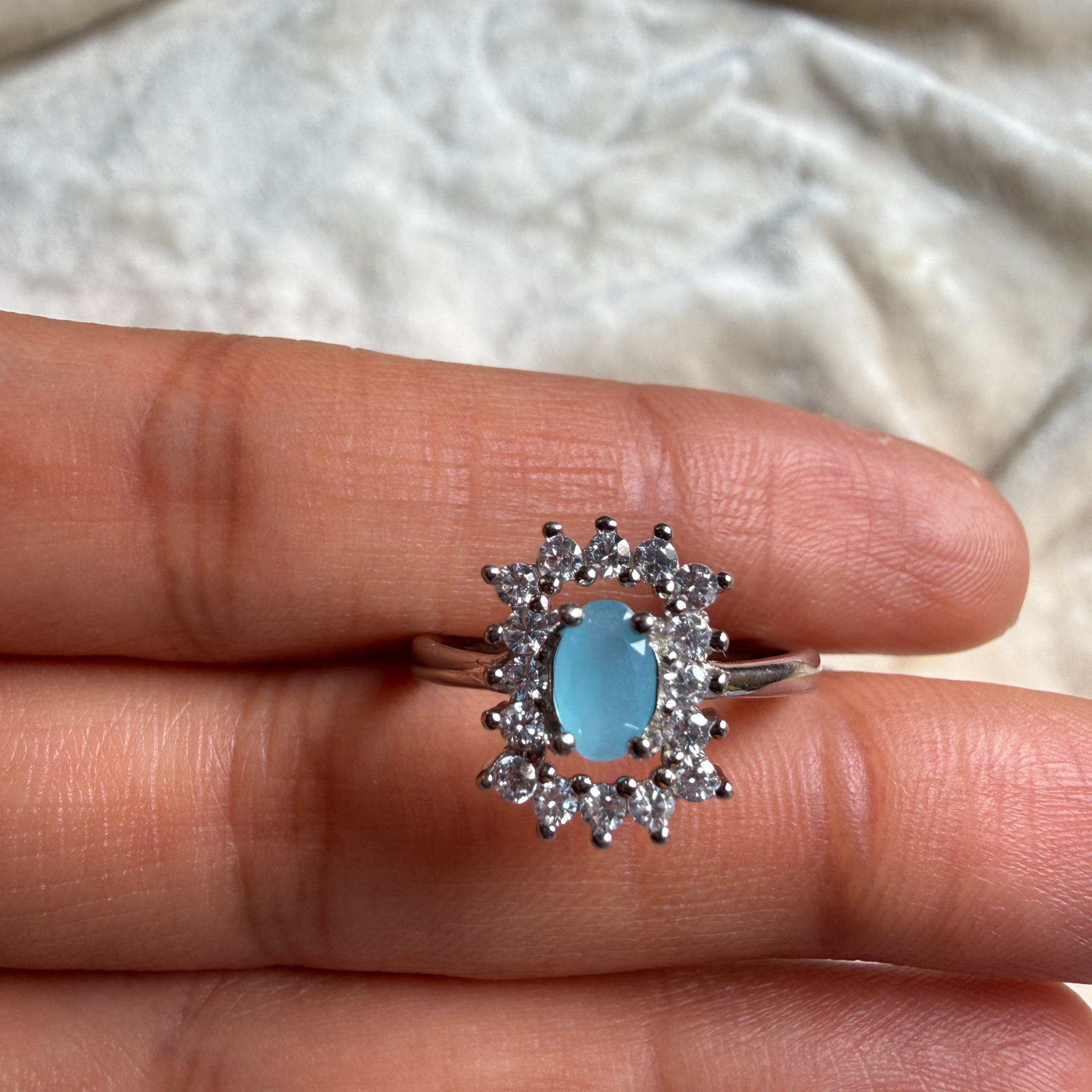 Sky blue oval gemstone and lab-grown diamond halo ring by Kiashaa Jewellery.