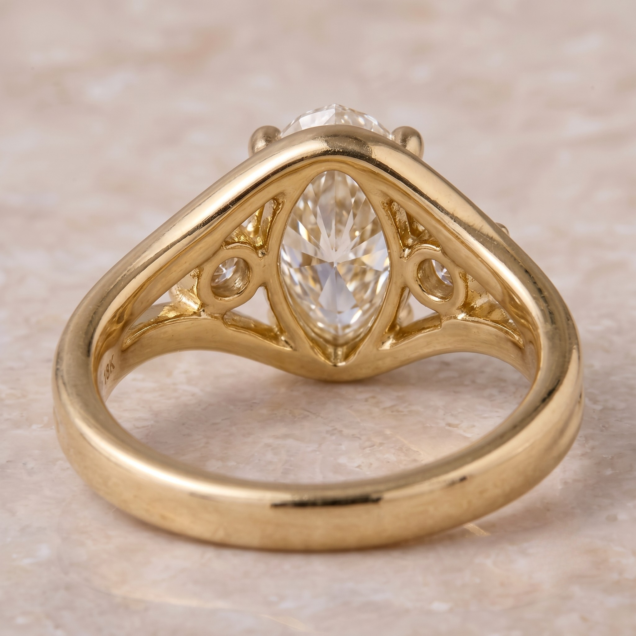 Yellow gold oval engagement ring with two round brilliant side diamonds