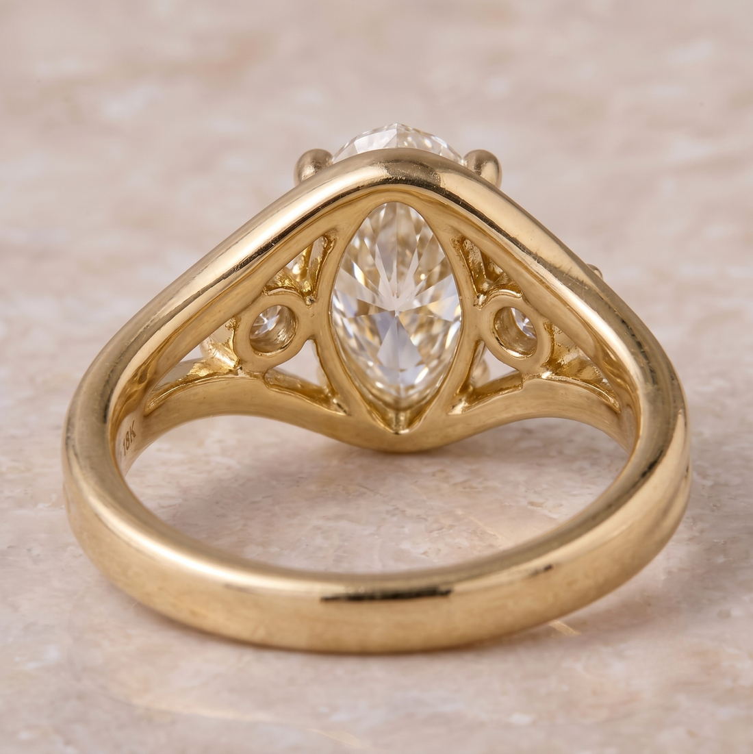 Yellow gold oval engagement ring with two round brilliant side diamonds