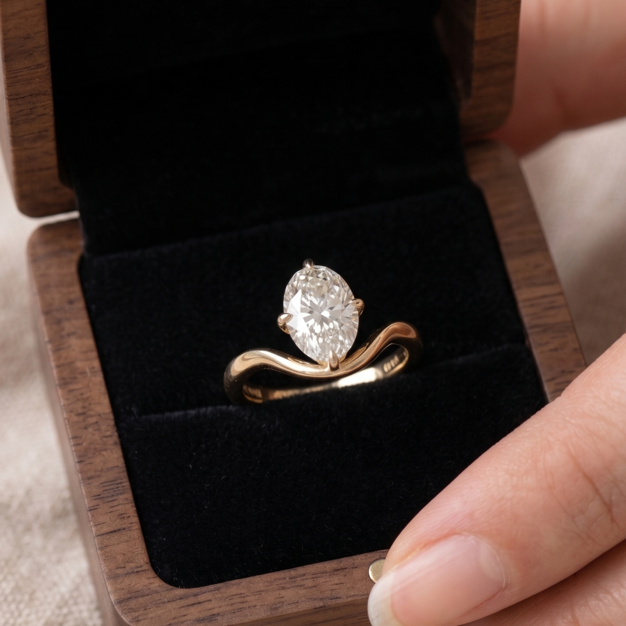 Large oval diamond solitaire ring with sculptural yellow gold band