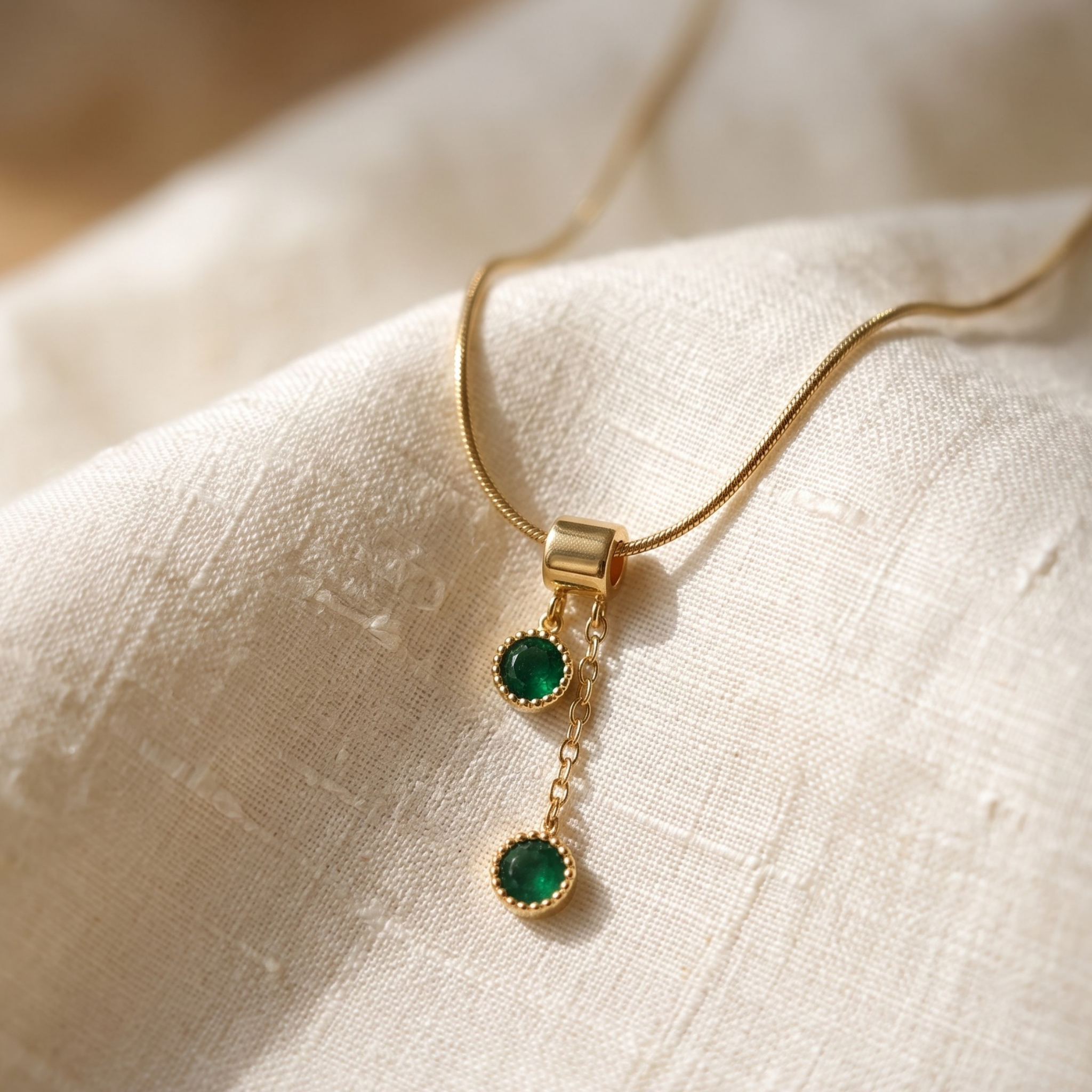  1.50 CTW green round gemstone drop necklace in polished yellow gold.