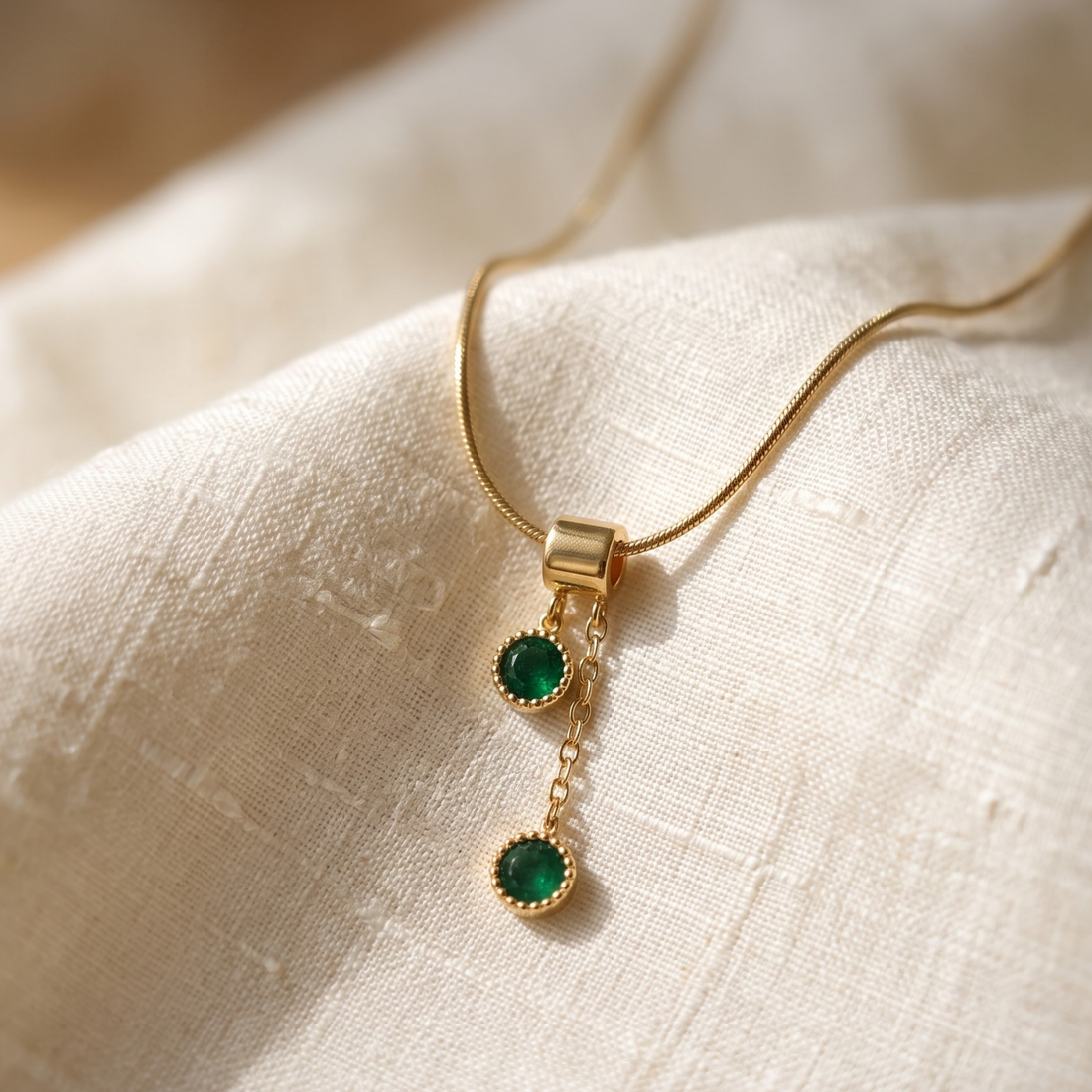  1.50 CTW green round gemstone drop necklace in polished yellow gold.