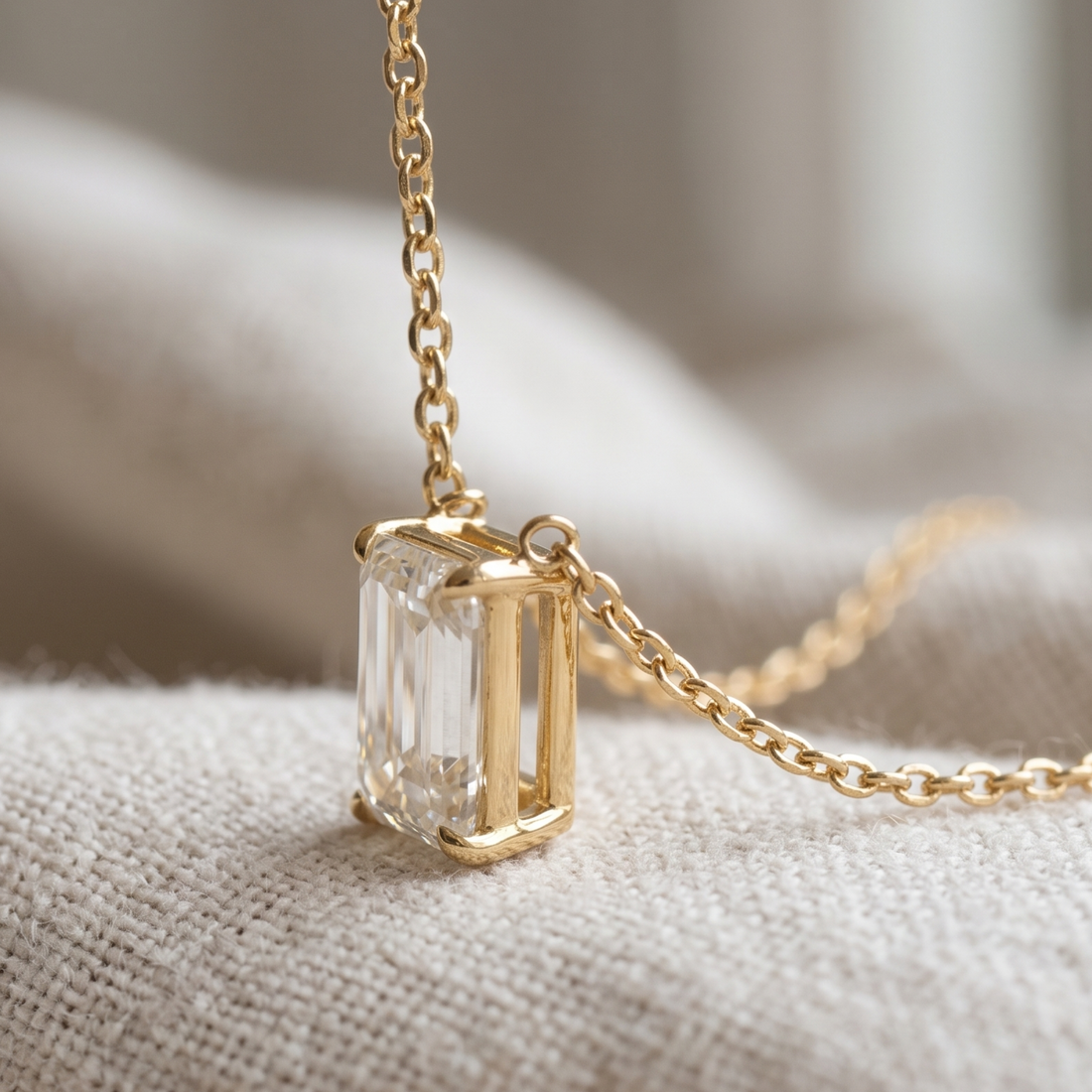 2.58 CT emerald-cut diamond solitaire pendant necklace in polished yellow gold.