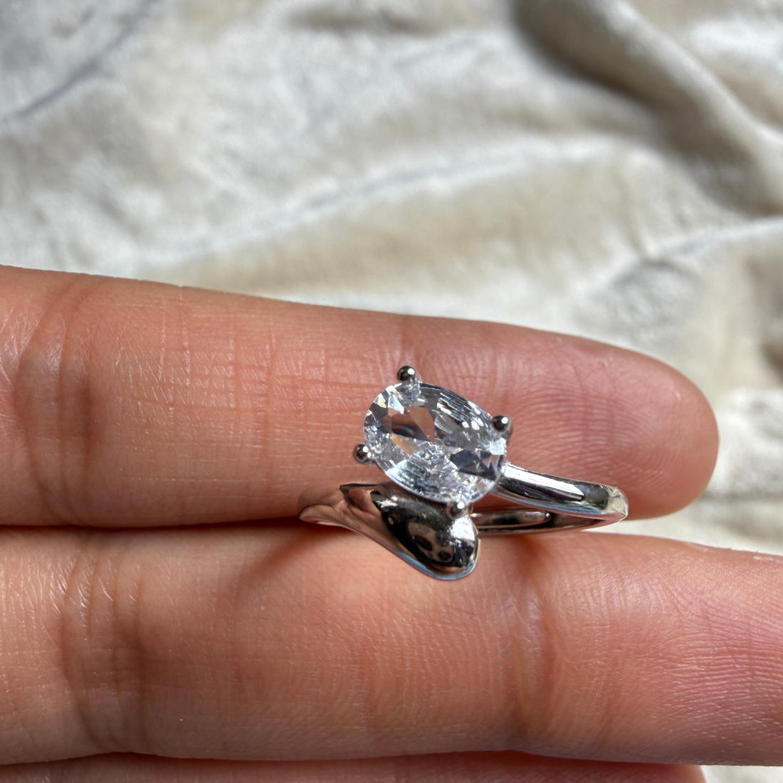 Oval lab-grown diamond bypass solitaire ring in white gold by Kiashaa Jewellery.