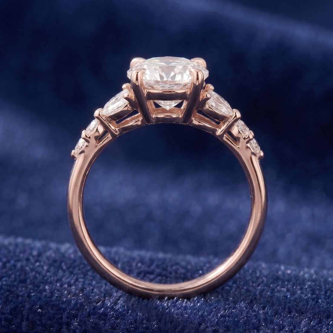 Round center diamond ring with 4 × 2 mm marquise side diamonds