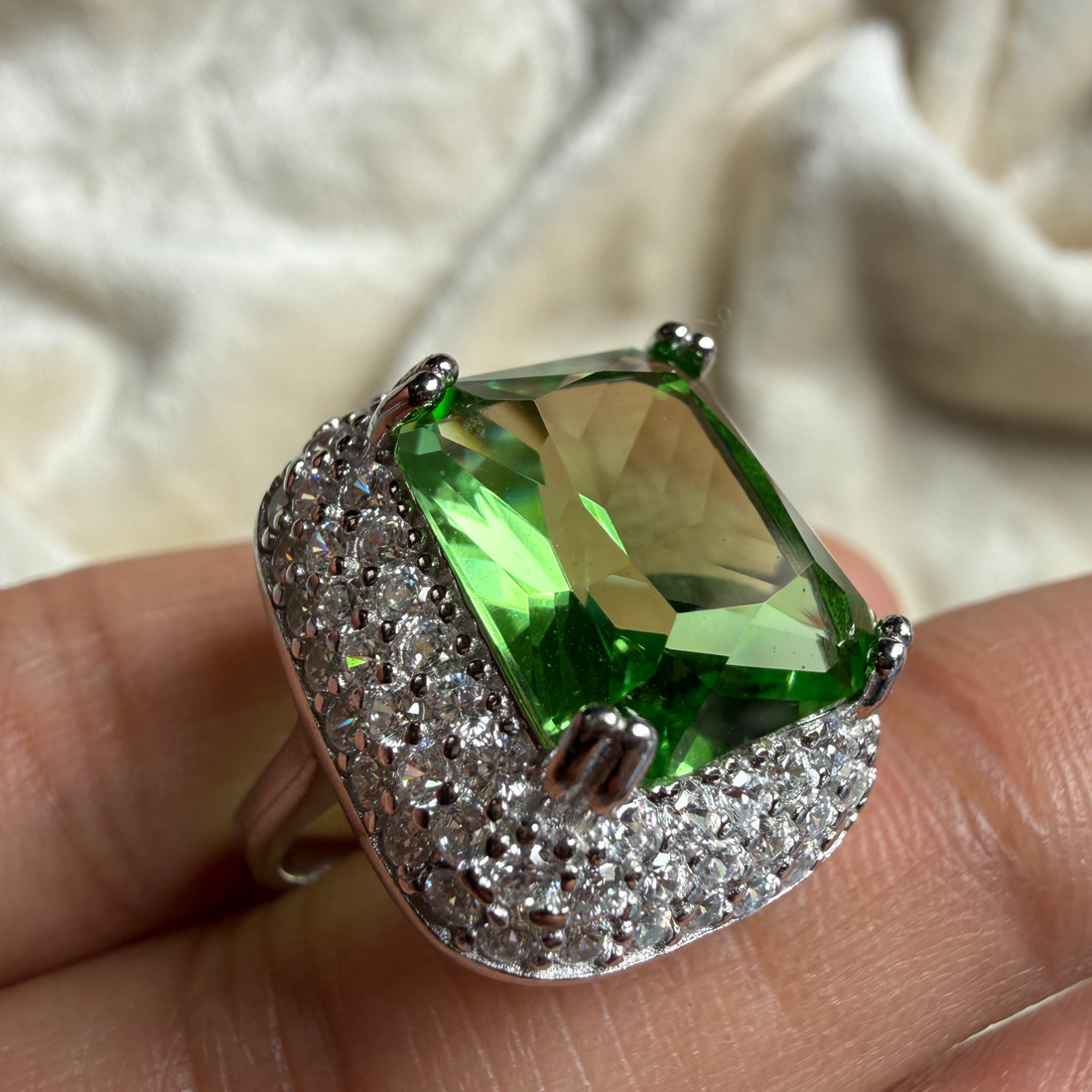 Green emerald-cut gemstone and lab-grown diamond double halo ring by Kiashaa Jewellery.