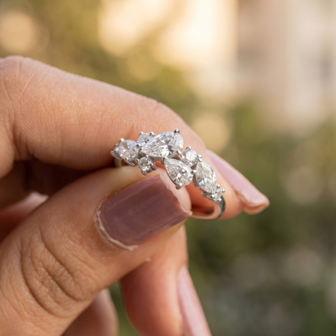 Handcrafted lab-grown diamond ring with pear and round brilliant stones.