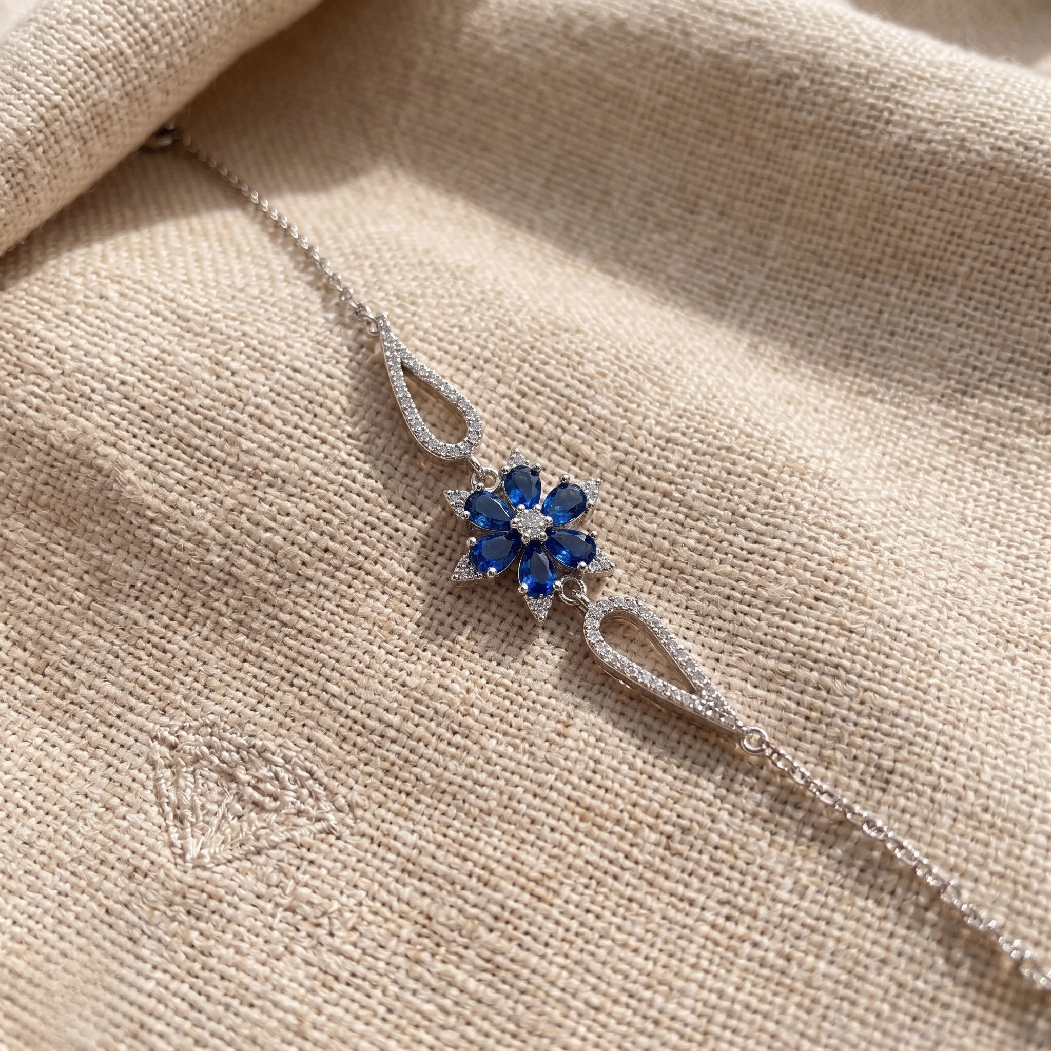 Blue pear gemstone and lab-grown diamond floral bracelet by Kiashaa Jewellery.