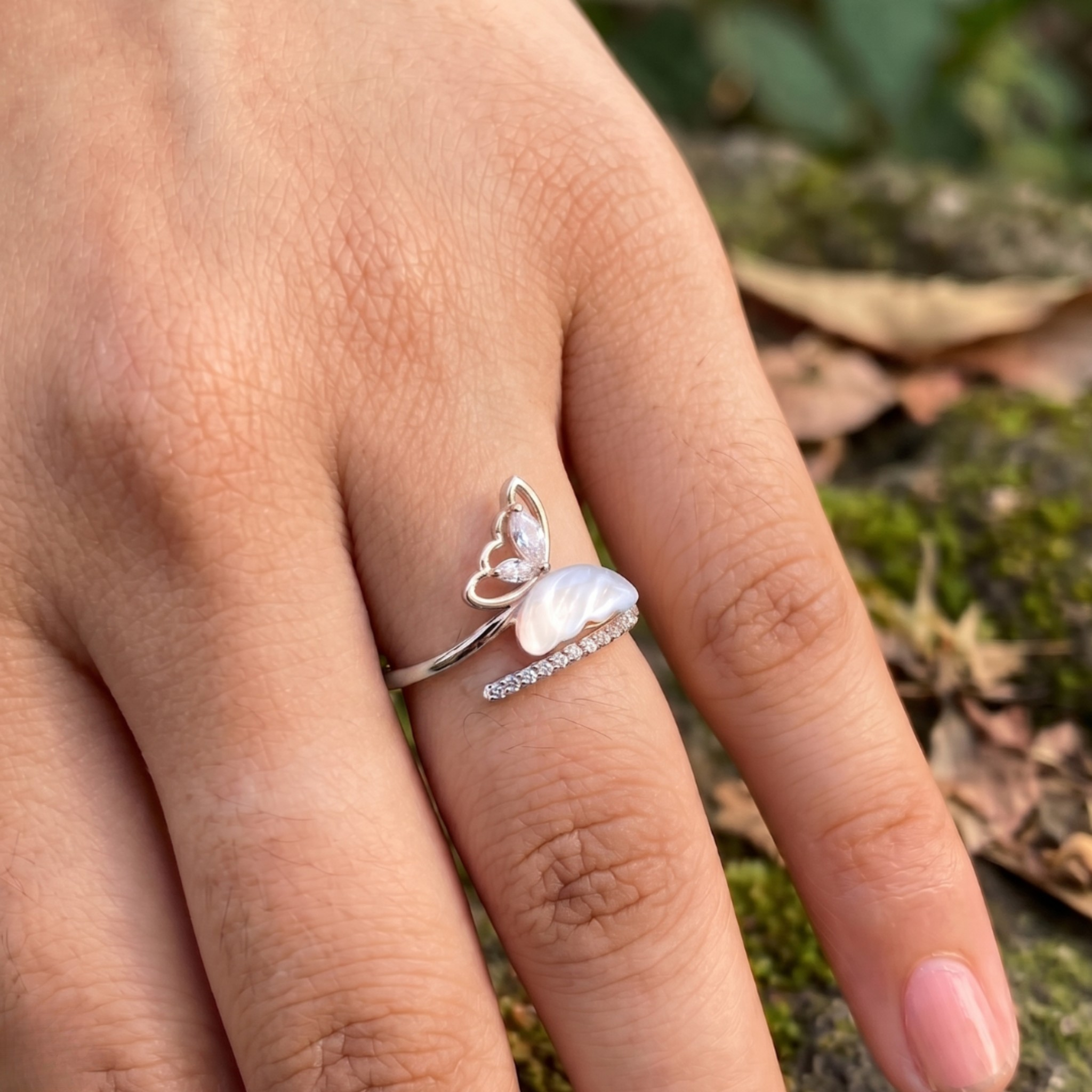 Nature-inspired open ring featuring marquise diamonds and a sculpted white pearl.