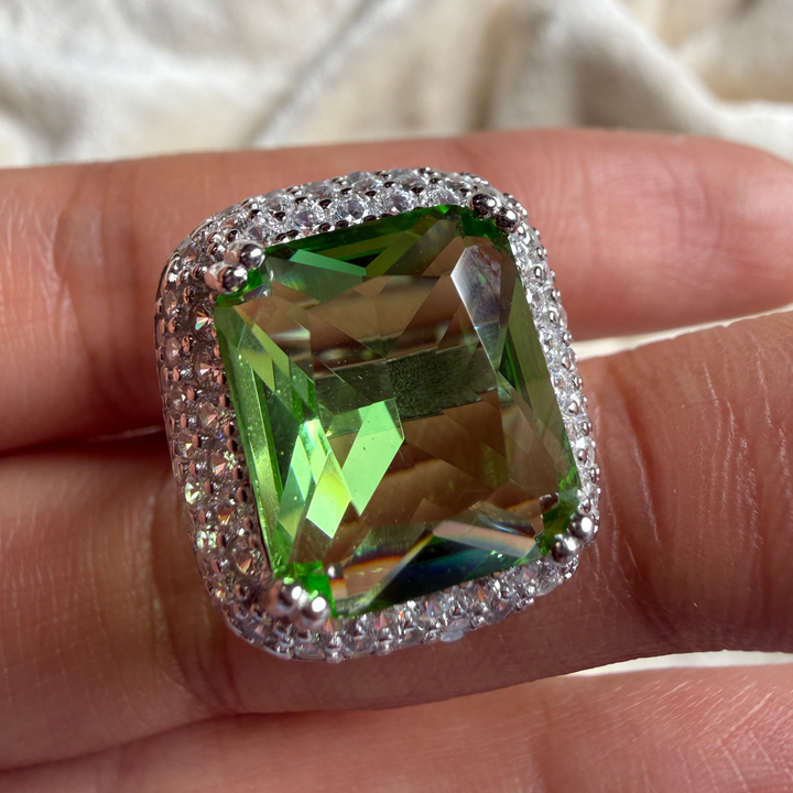Green emerald-cut gemstone and lab-grown diamond double halo ring by Kiashaa Jewellery.