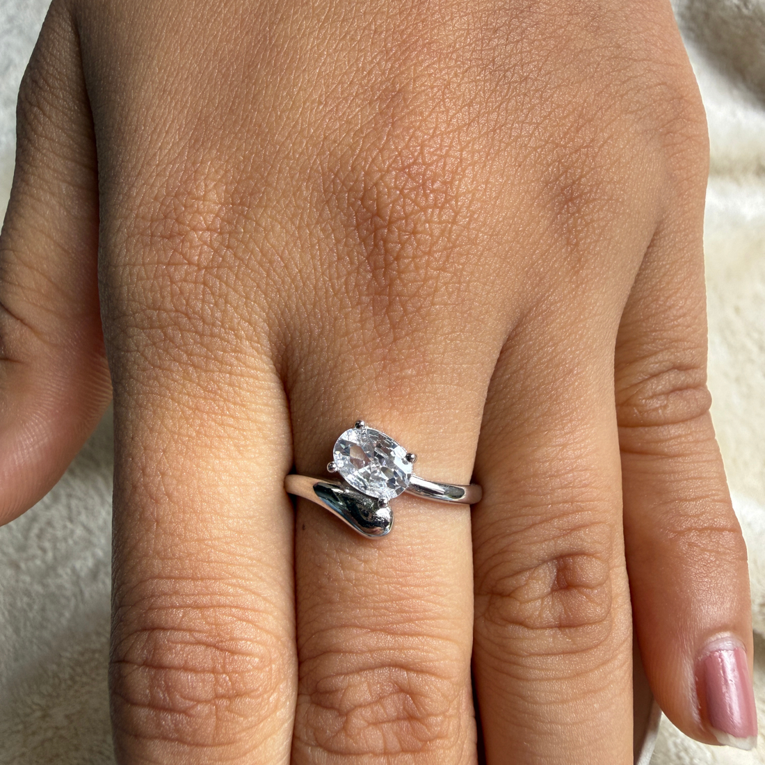 Oval lab-grown diamond bypass solitaire ring in white gold by Kiashaa Jewellery.