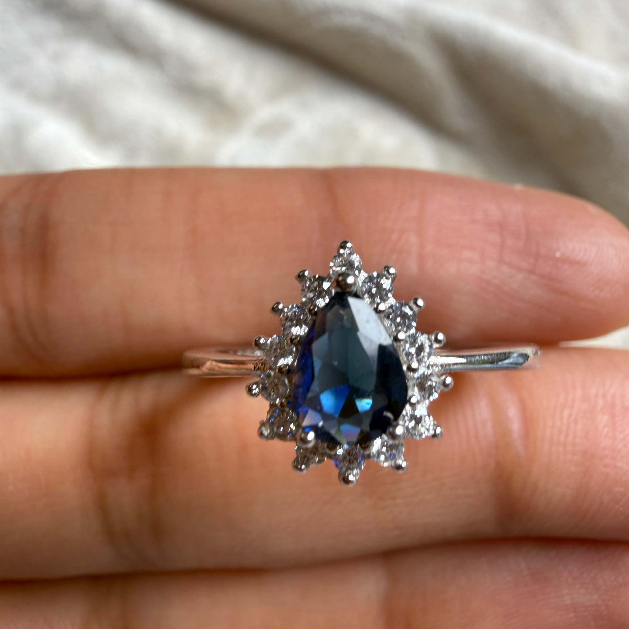 Blue pear gemstone and lab-grown diamond halo ring by Kiashaa Jewellery.