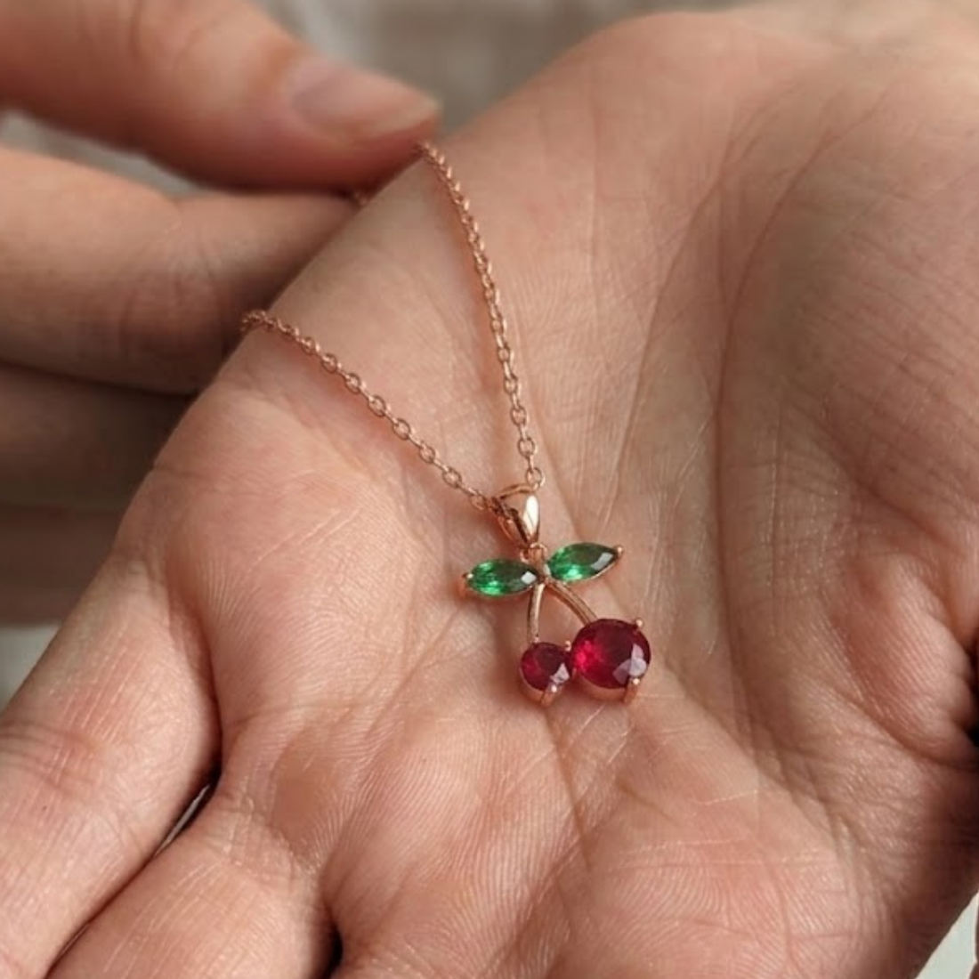 Four-stone green diamond and red gemstone necklace with a premium high-polish gold finish.