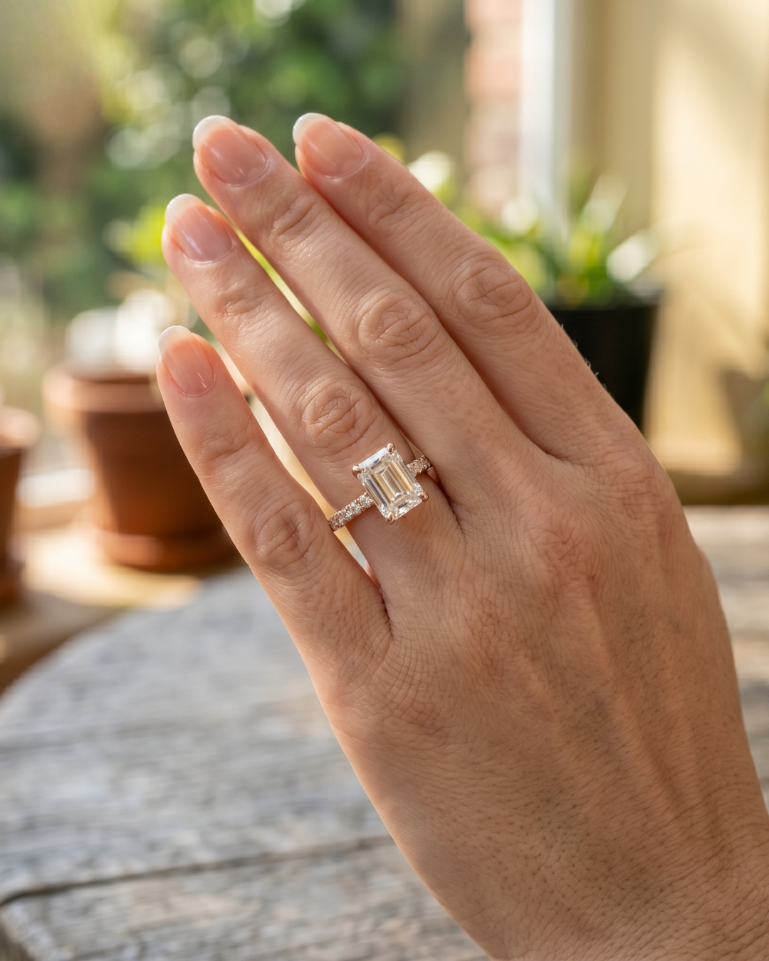 Emerald-cut engagement ring with round accent diamonds by Kiashaa Jewellery.