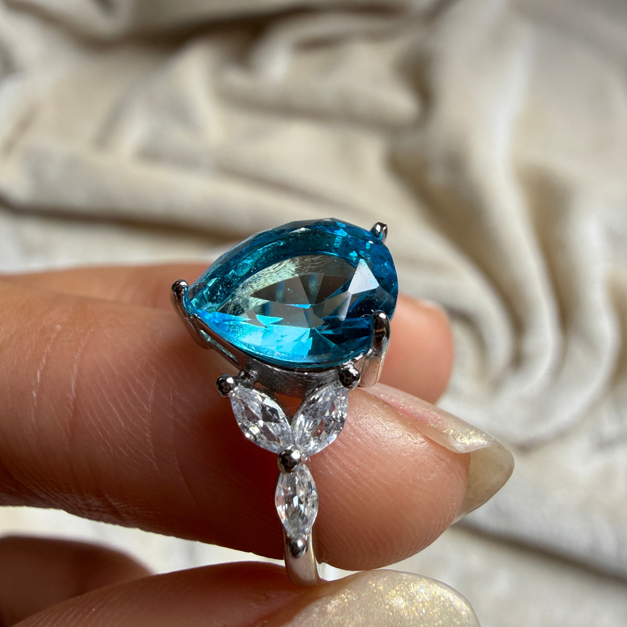 Blue pear gemstone and marquise lab-grown diamond ring by Kiashaa Jewellery.