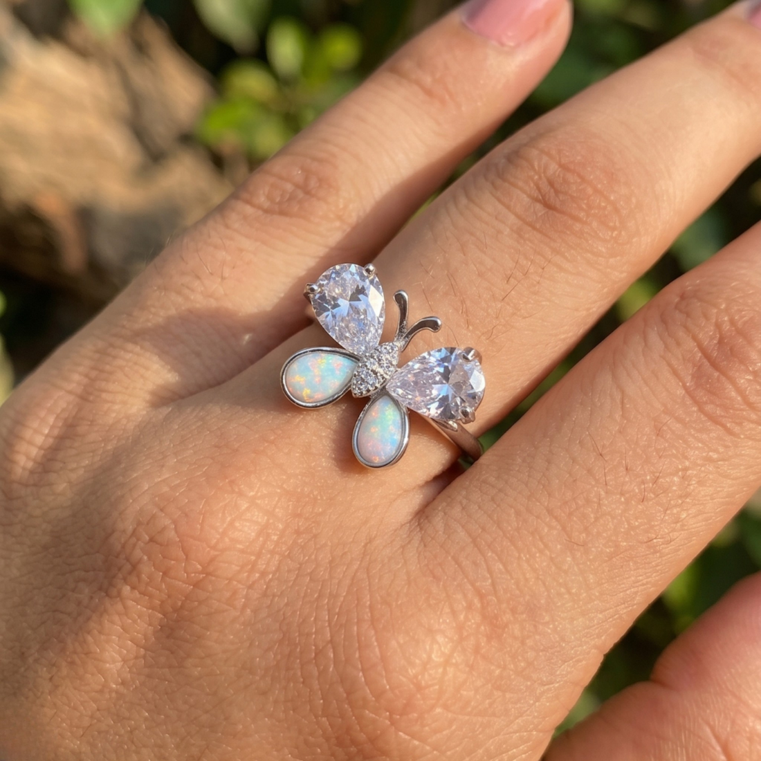 Nature-inspired butterfly ring featuring pear-shaped lab-grown diamonds and opal gemstones.