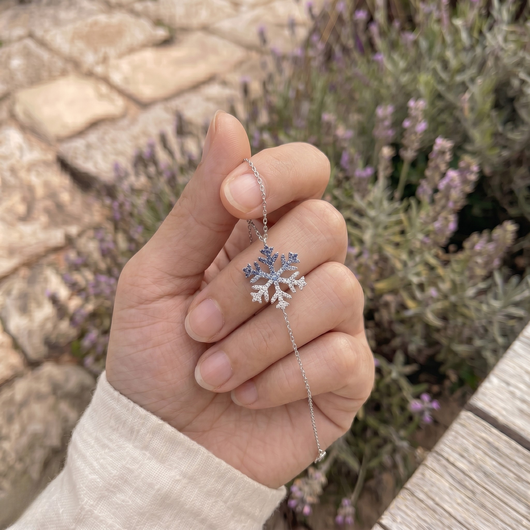 Blue gemstone and lab-grown diamond snowflake bracelet by Kiashaa Jewellery.