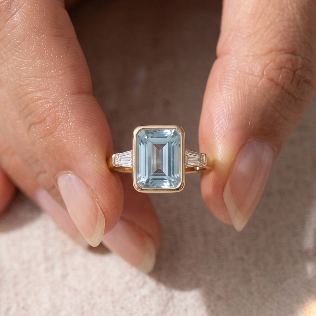 Bezel-style rectangular center ring with tapered baguette side stones
