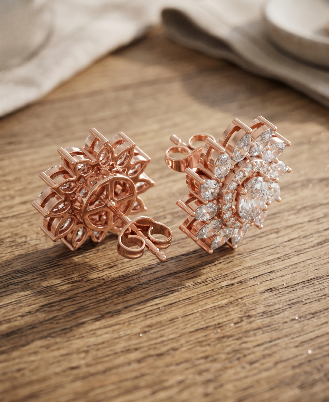 Front and back view of rose gold floral diamond stud earrings showing the raised open gallery and push-back closure.