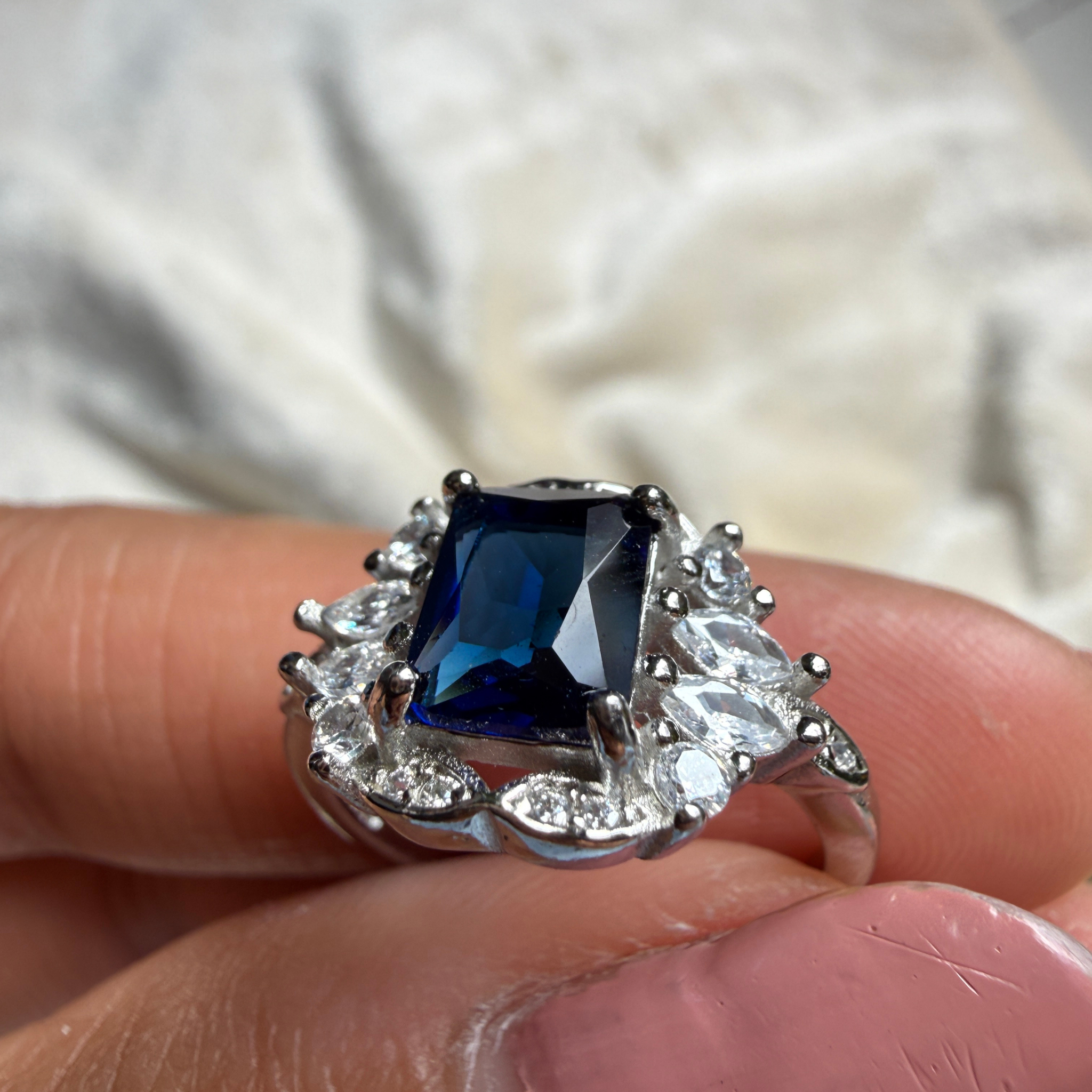 Blue emerald gemstone and lab-grown diamond halo ring by Kiashaa Jewellery.