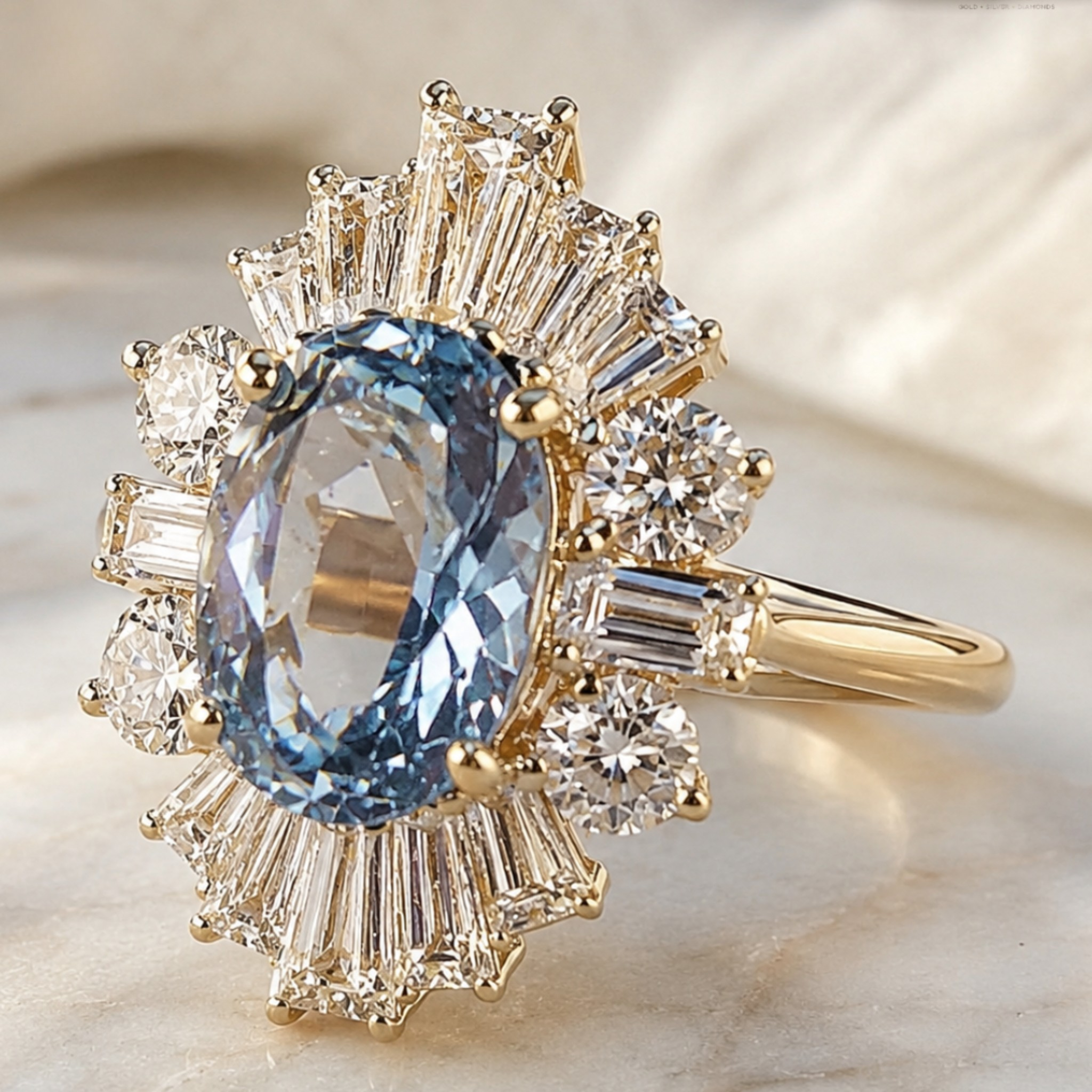 A yellow gold ring featuring a large oval light blue gemstone surrounded by a radiant halo of baguette and round clear stones, displayed on a soft beige marble surface.