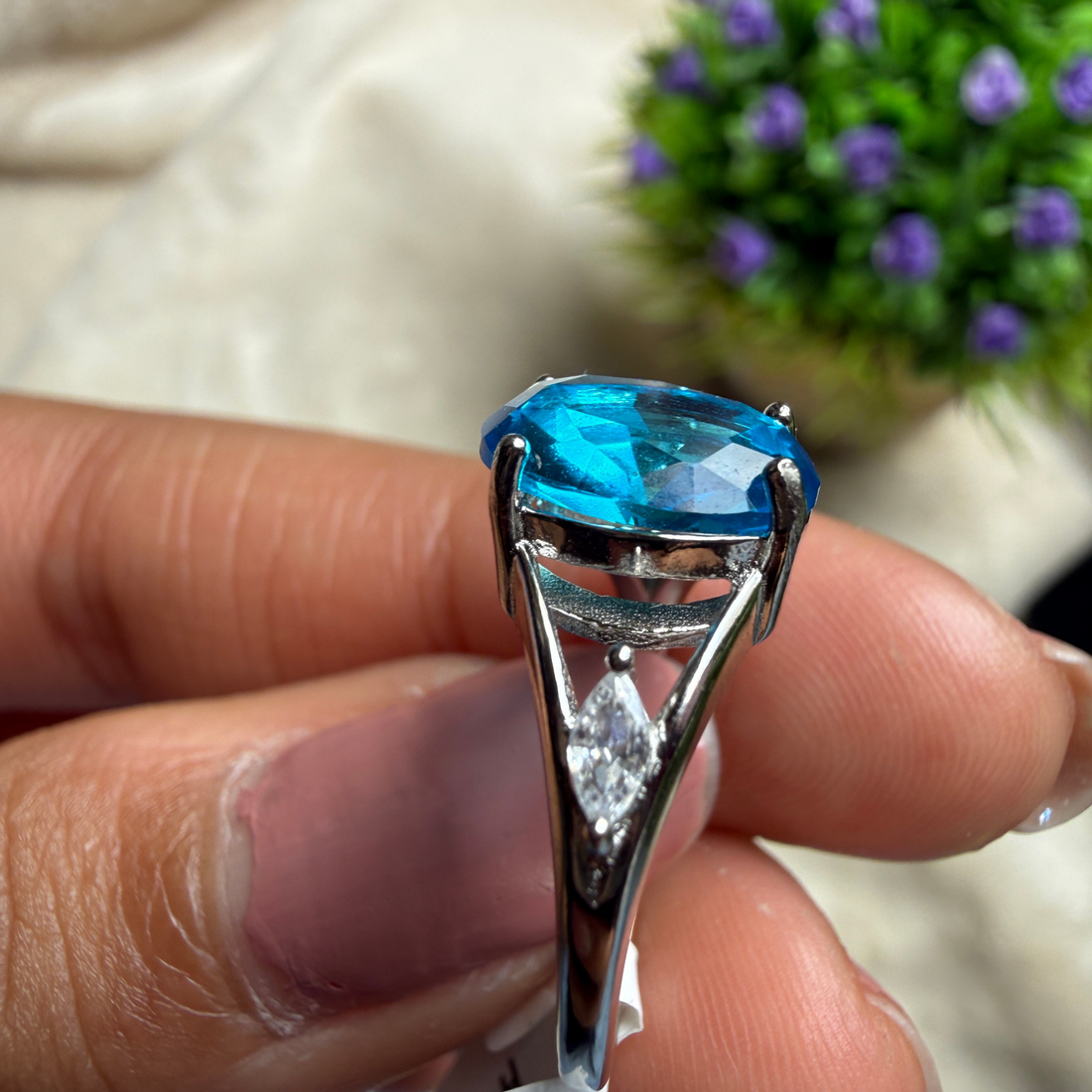 Blue oval gemstone solitaire ring with marquise lab-grown diamonds by Kiashaa Jewellery.