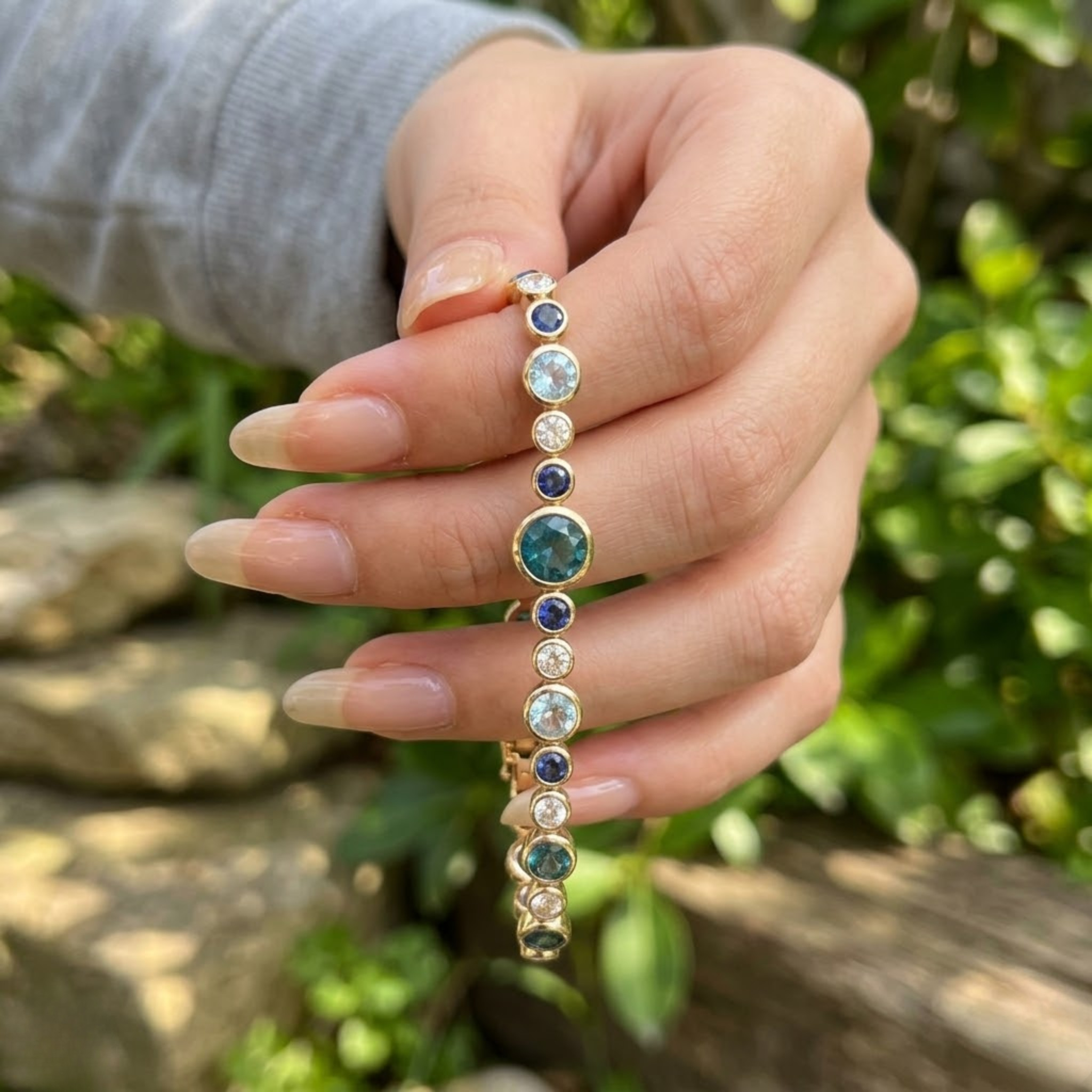 Rainbow bracelet featuring a continuous row of vibrant round gemstones.