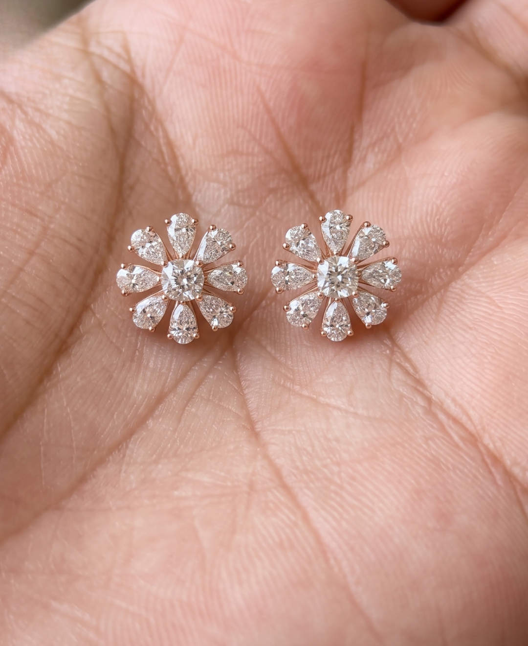 Luxury flower-shaped diamond stud earrings by Kiashaa Jewellery with prong-set cushion and pear diamonds.