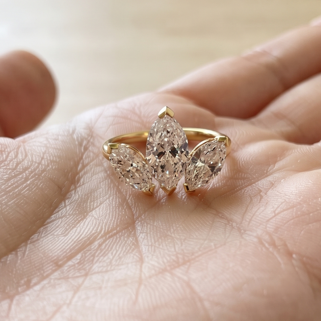  Close-up of a three-marquise diamond ring with delicate prong settings.