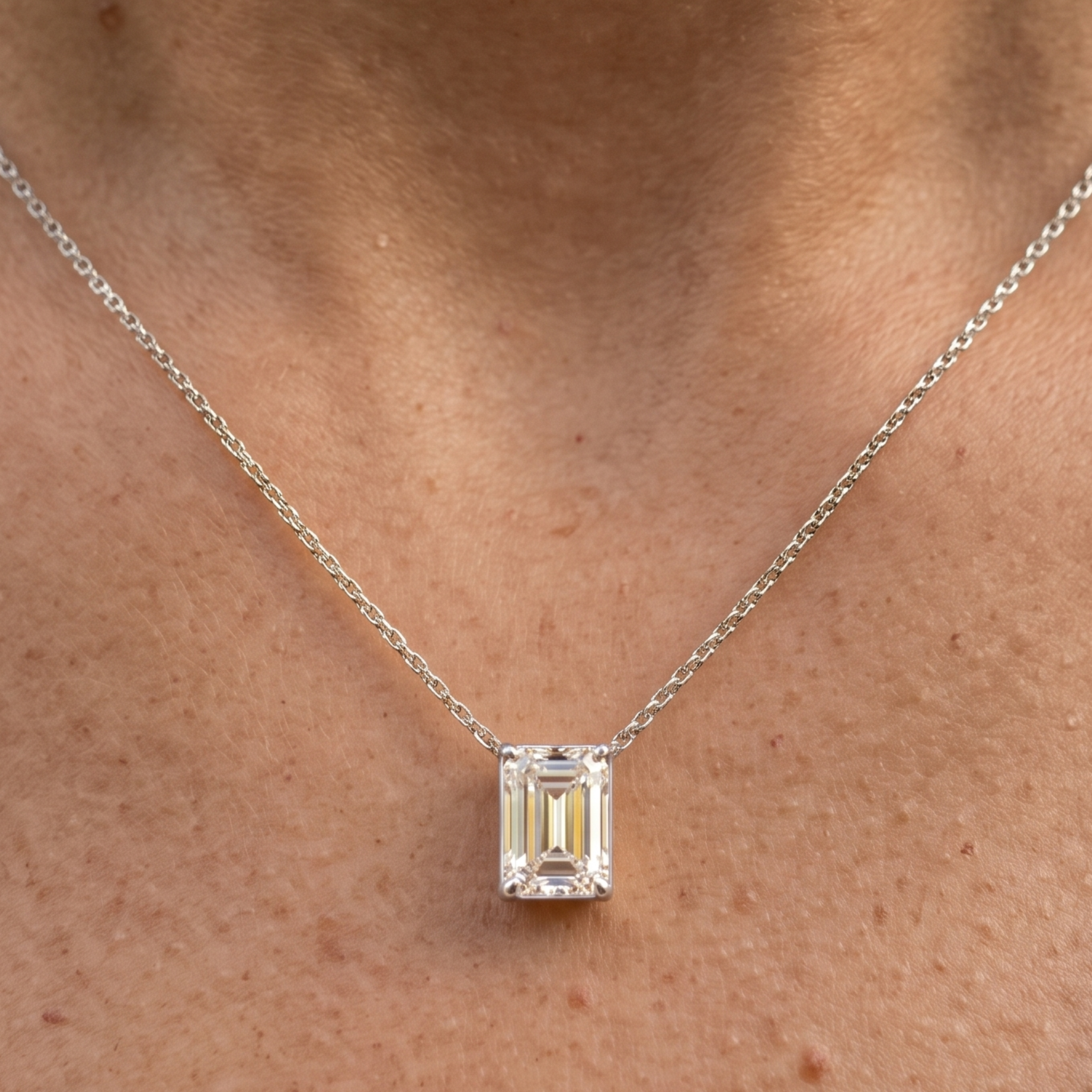 2.58 CT emerald-cut diamond solitaire pendant necklace in polished yellow gold.