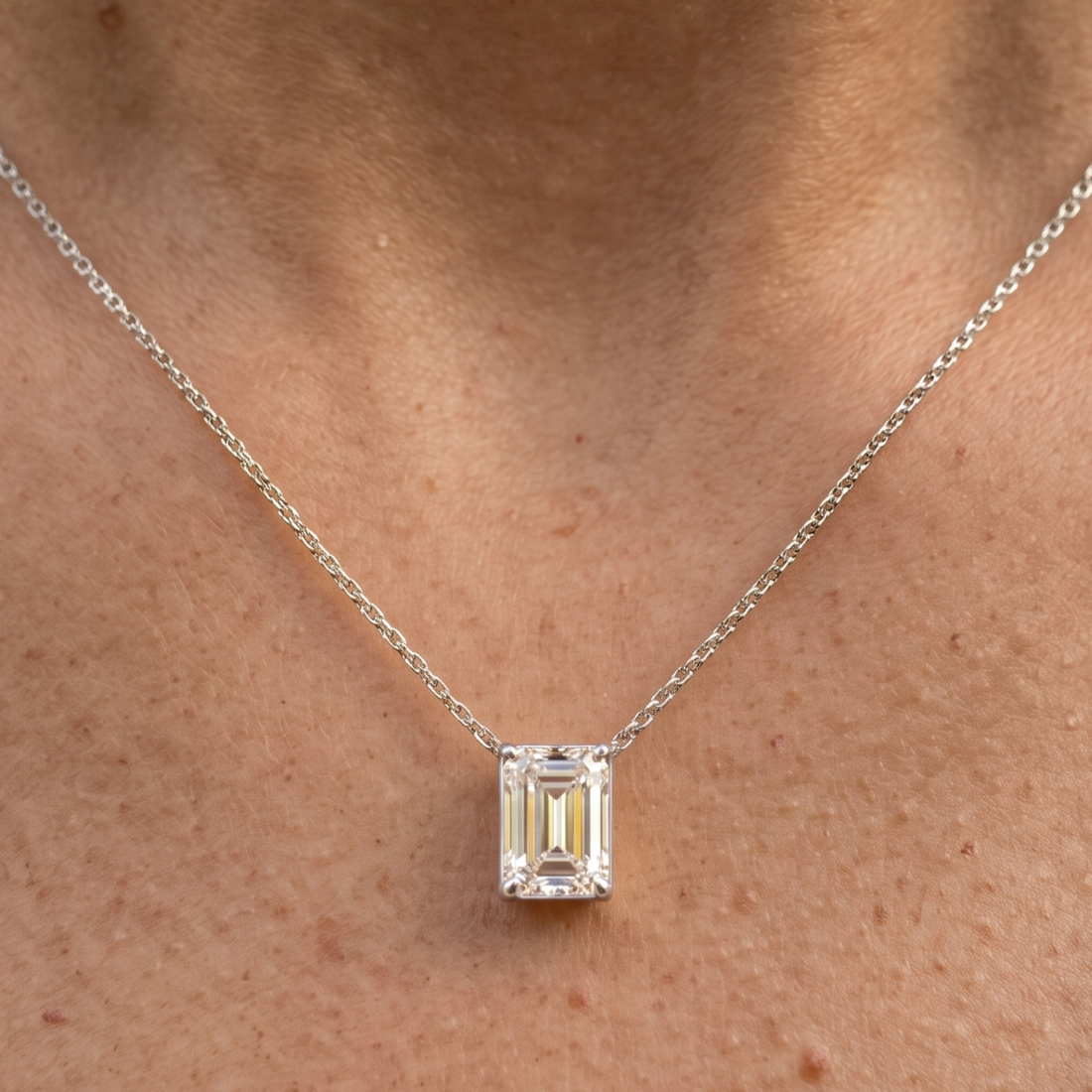 2.58 CT emerald-cut diamond solitaire pendant necklace in polished yellow gold.