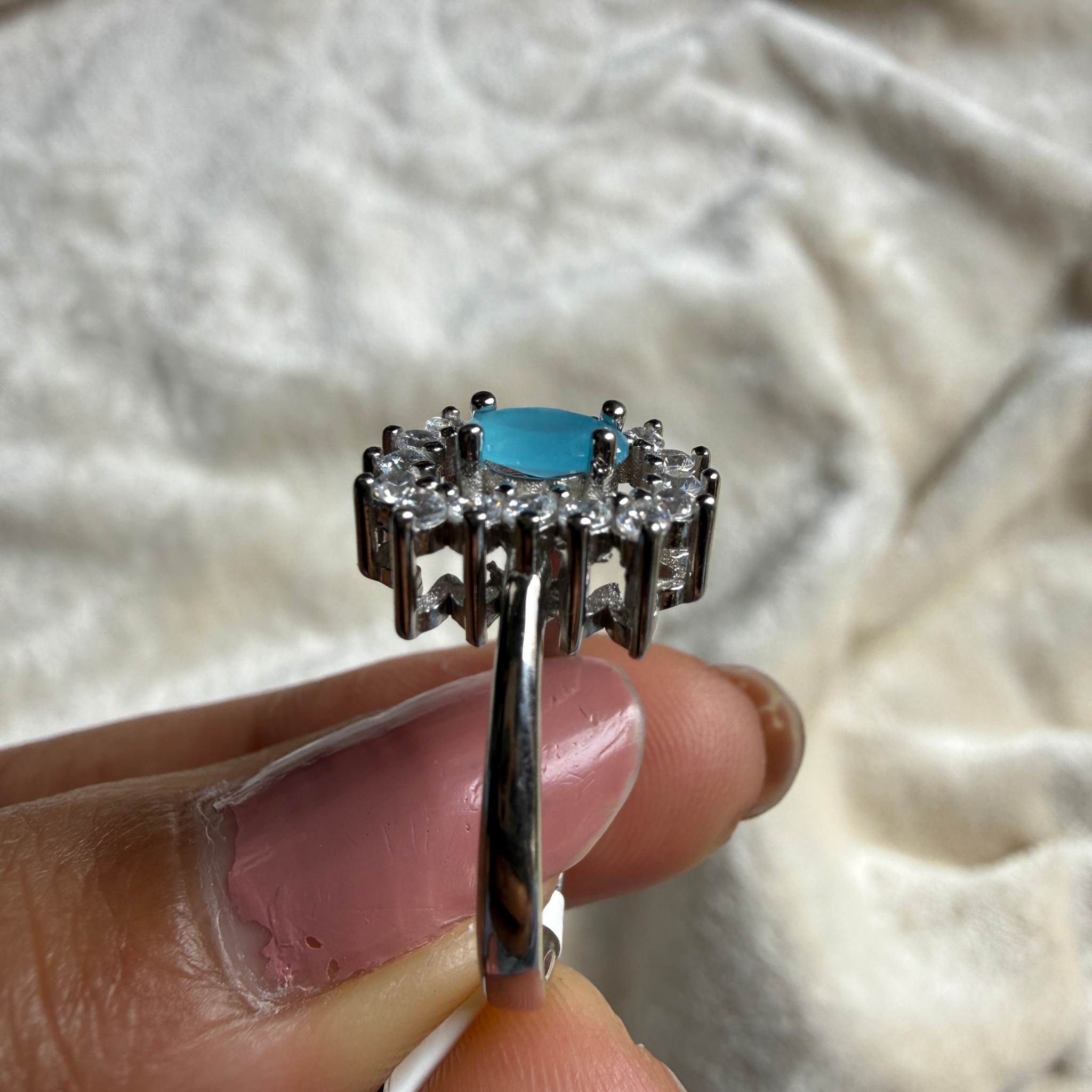 Sky blue oval gemstone and lab-grown diamond halo ring by Kiashaa Jewellery.