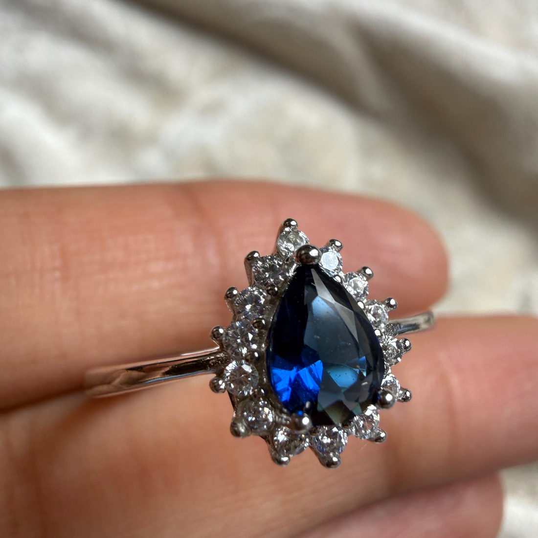 Blue pear gemstone and lab-grown diamond halo ring by Kiashaa Jewellery.