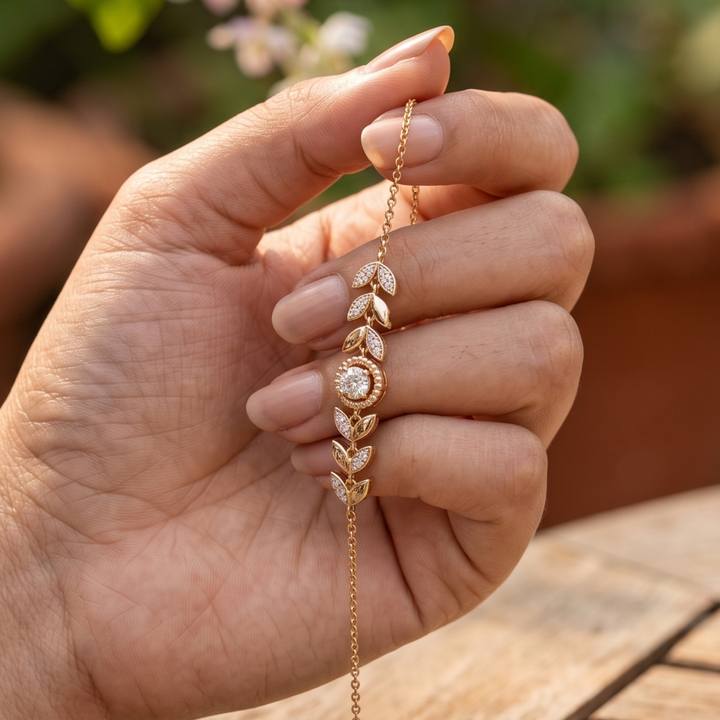 Botanical diamond bracelet featuring a 5.10 mm round center stone with leaf motifs.