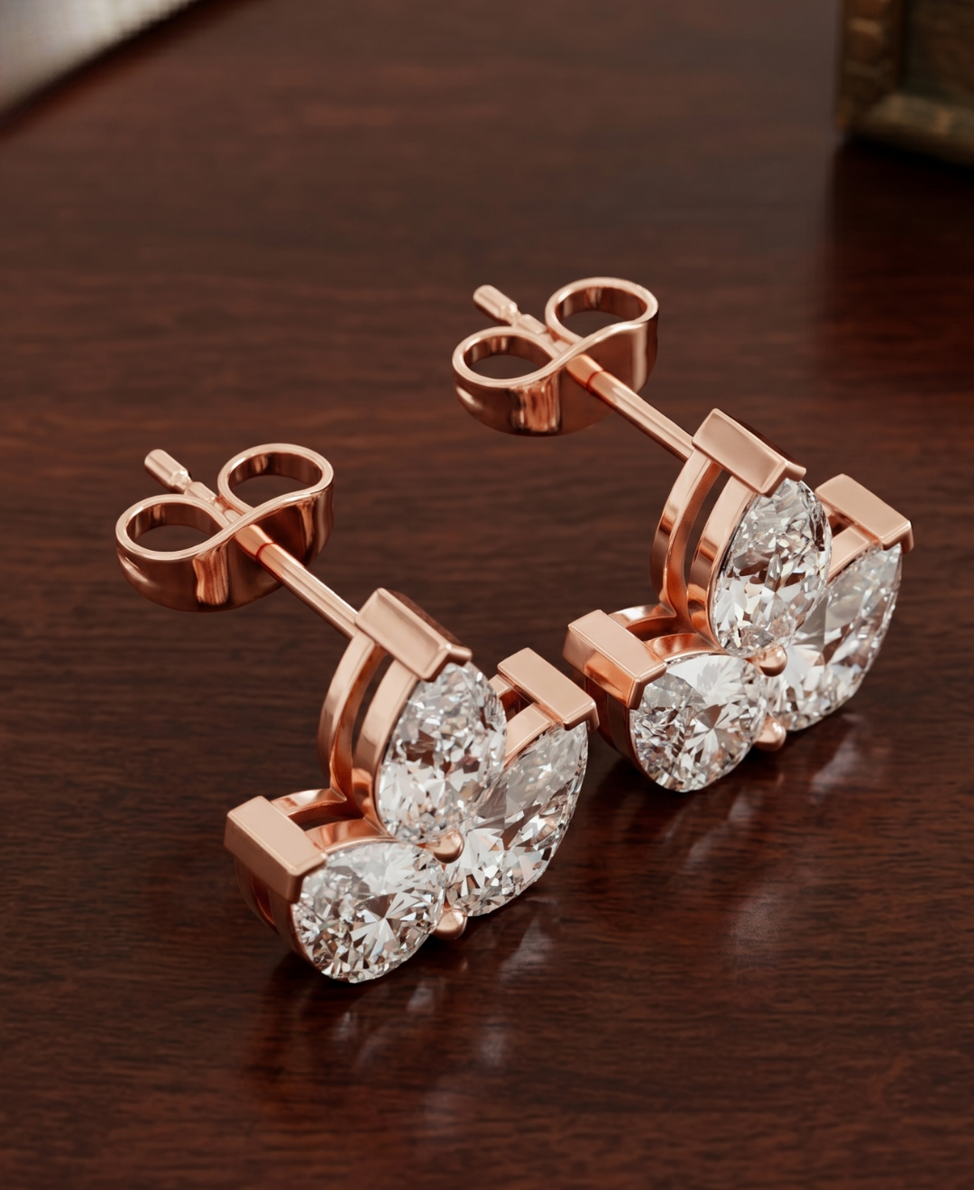 Elegant ladies stud earrings with pear-shaped diamonds in floral-inspired arrangement.