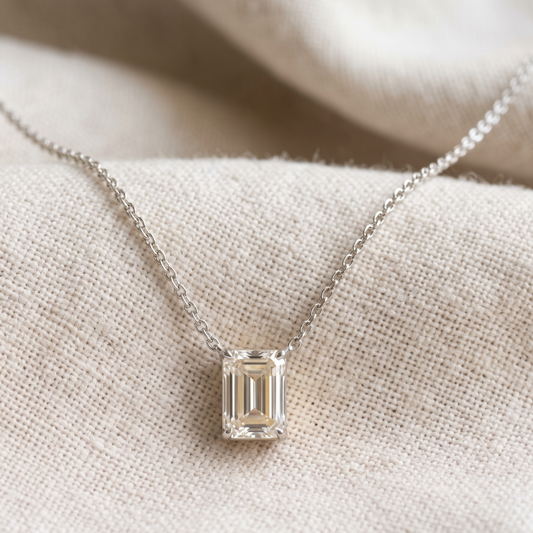 2.58 CT emerald-cut diamond solitaire pendant necklace in polished yellow gold.