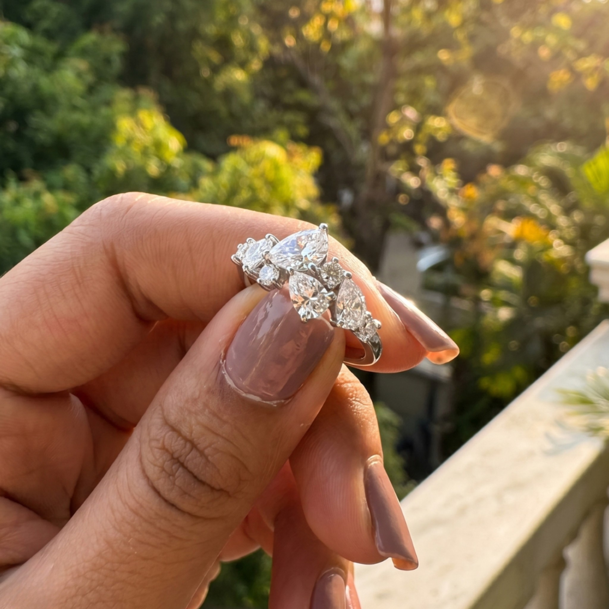 Handcrafted lab-grown diamond ring with pear and round brilliant stones.