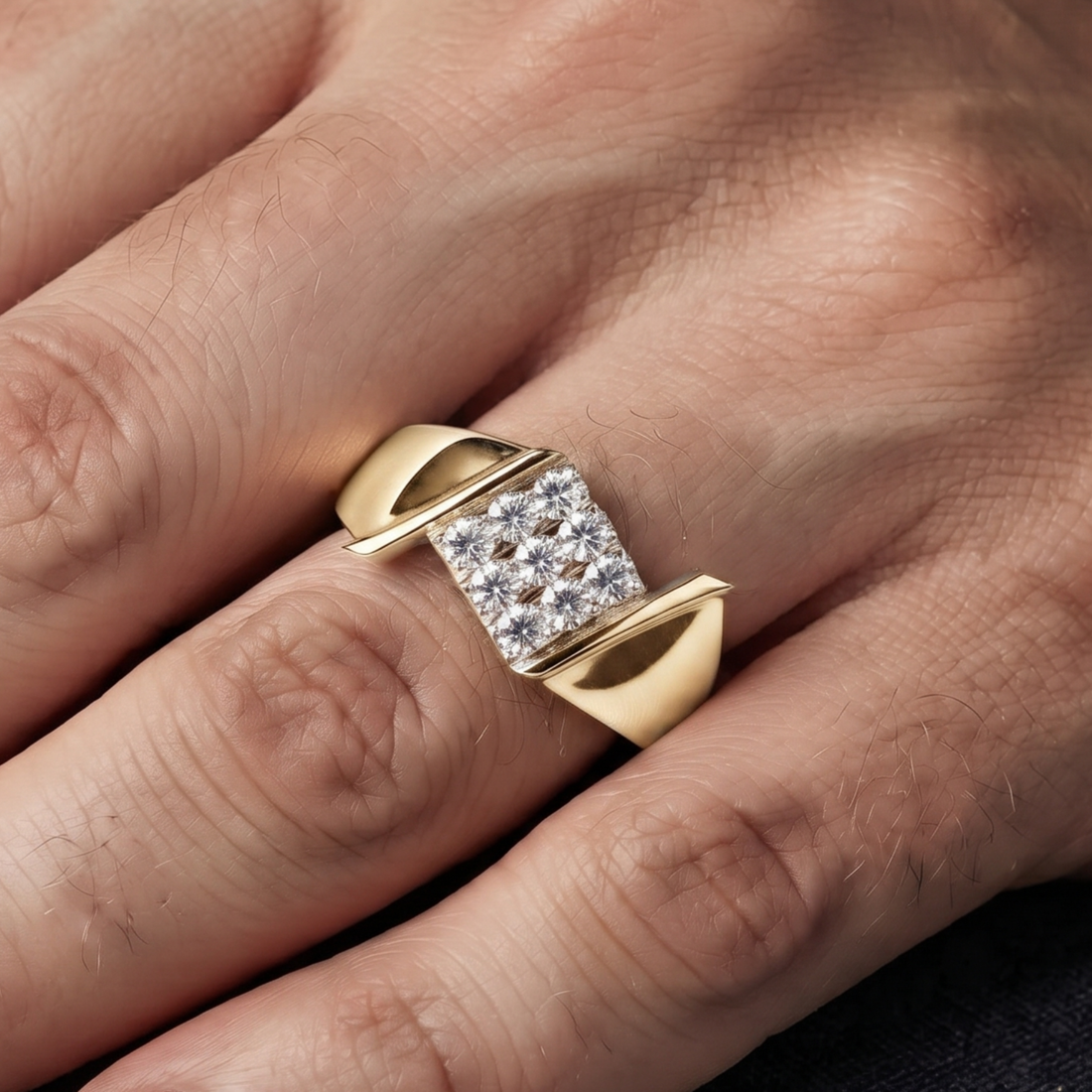 A yellow gold ring with a square pavé diamond center, shown worn on a person's finger. 