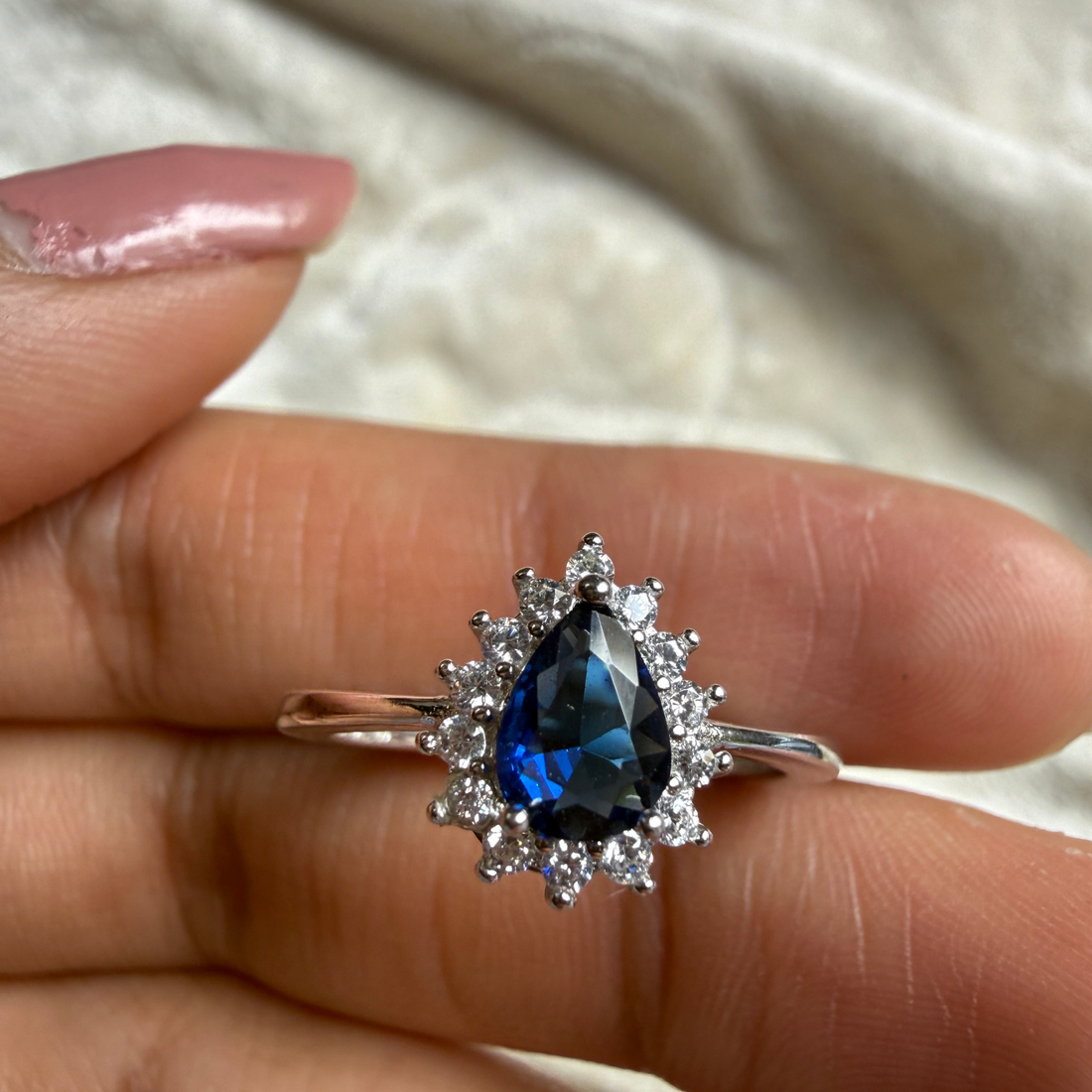 Blue pear gemstone and lab-grown diamond halo ring by Kiashaa Jewellery.