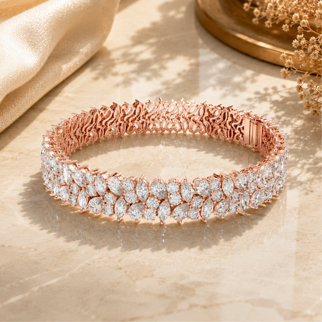 A rose gold tennis bracelet adorned with all Daimond cut clear stones, displayed on a beige marble surface with soft shadows and decorative fabric in the background.