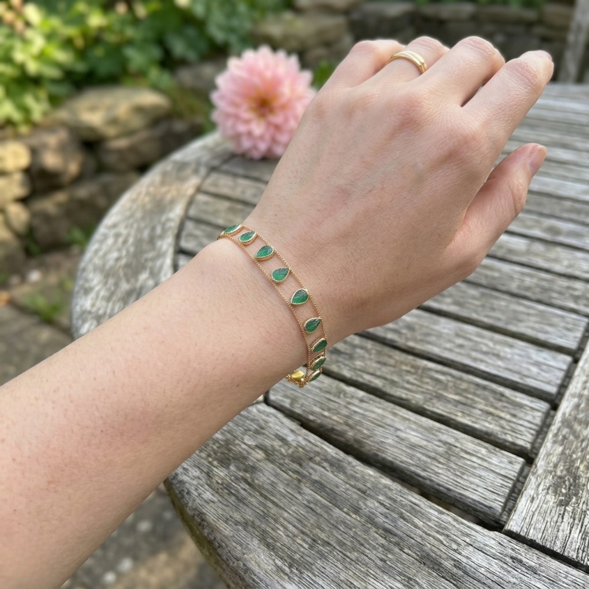 Elegant botanical bracelet with pear and marquise-shaped green crystal stations.