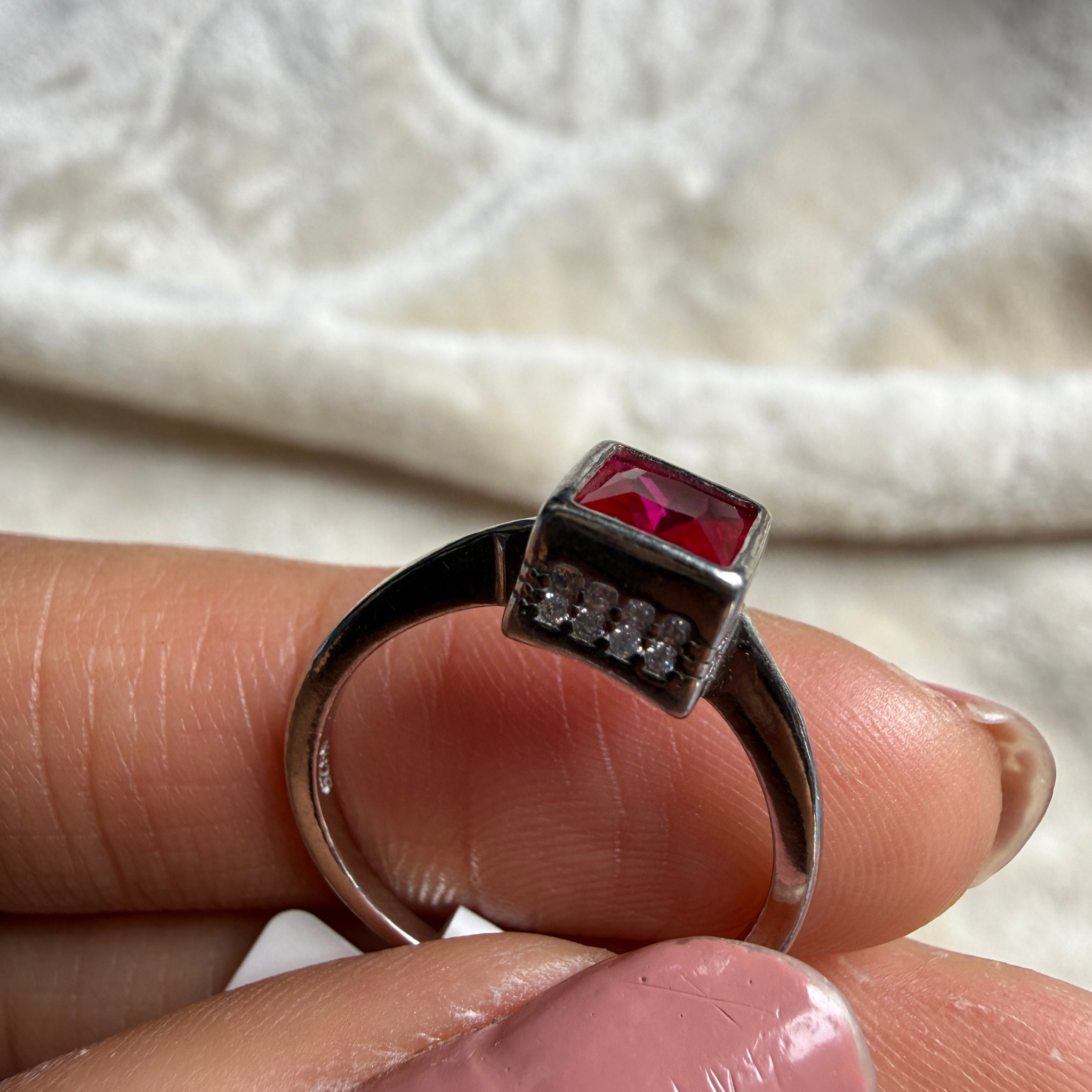 Red princess-cut gemstone solitaire ring in white gold by Kiashaa Jewellery.
