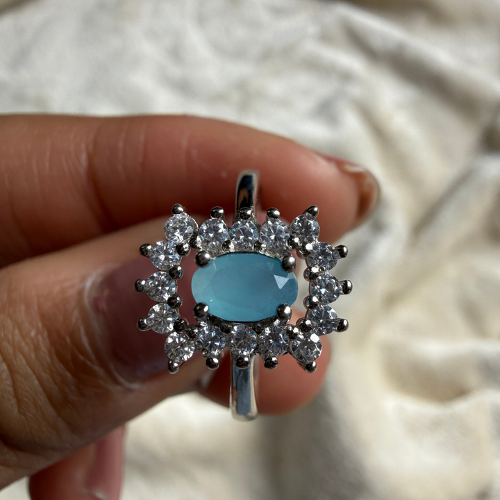 Sky blue oval gemstone and lab-grown diamond halo ring by Kiashaa Jewellery.