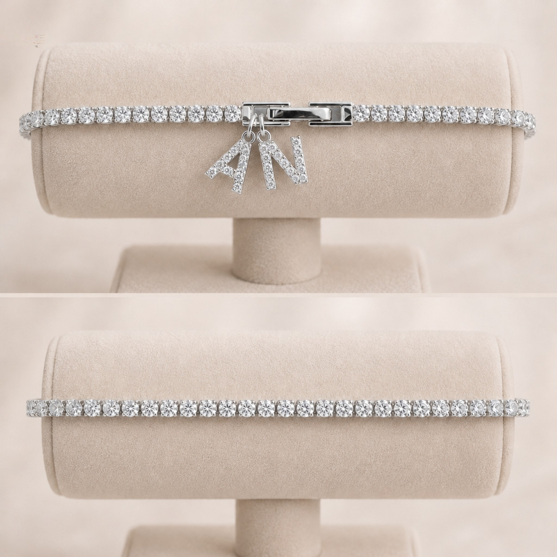 A silver-tone tennis bracelet with a bow charm, set with clear stones, displayed on a beige jewelry stand against a matching beige background.