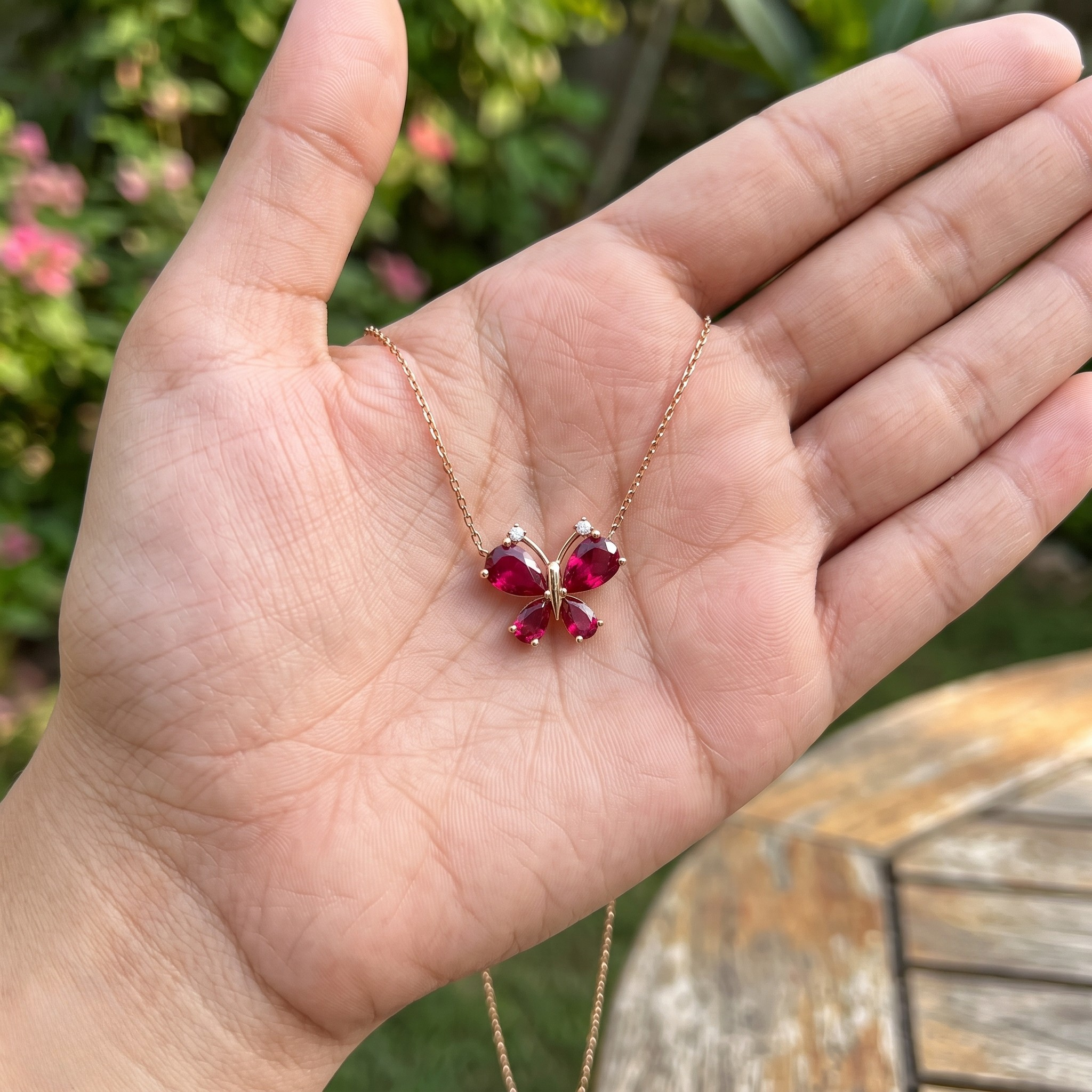 Red pear gemstone butterfly pendant necklace with lab-grown diamond accents by Kiashaa Jewellery.