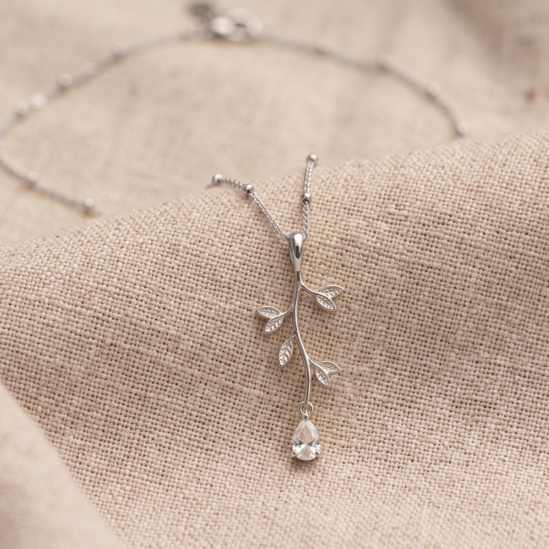 Kiashaa Jewellery 0.39 CT pear diamond leaf pendant necklace in polished yellow gold.